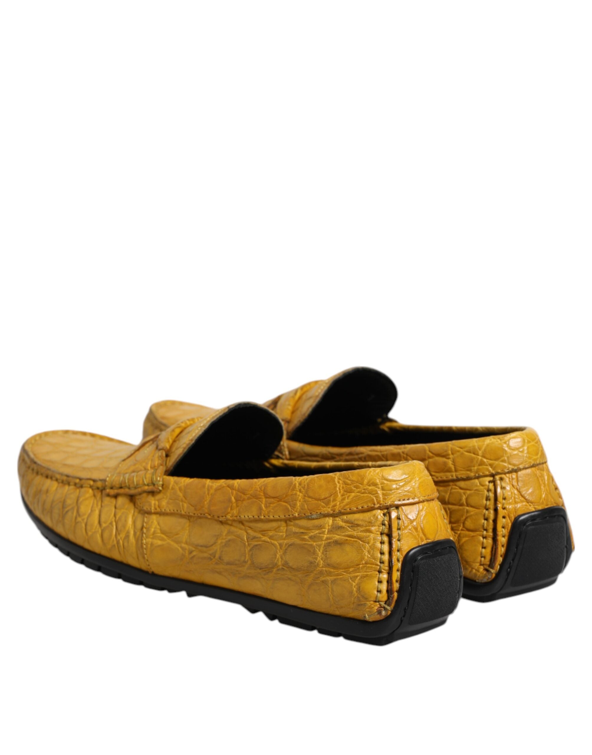 Experience the allure of Dolce & Gabbana's Yellow Exotic Leather Loafers, crafted from sumptuous Caiman leather, epitomizing luxury and timeless elegance for the discerning individual.