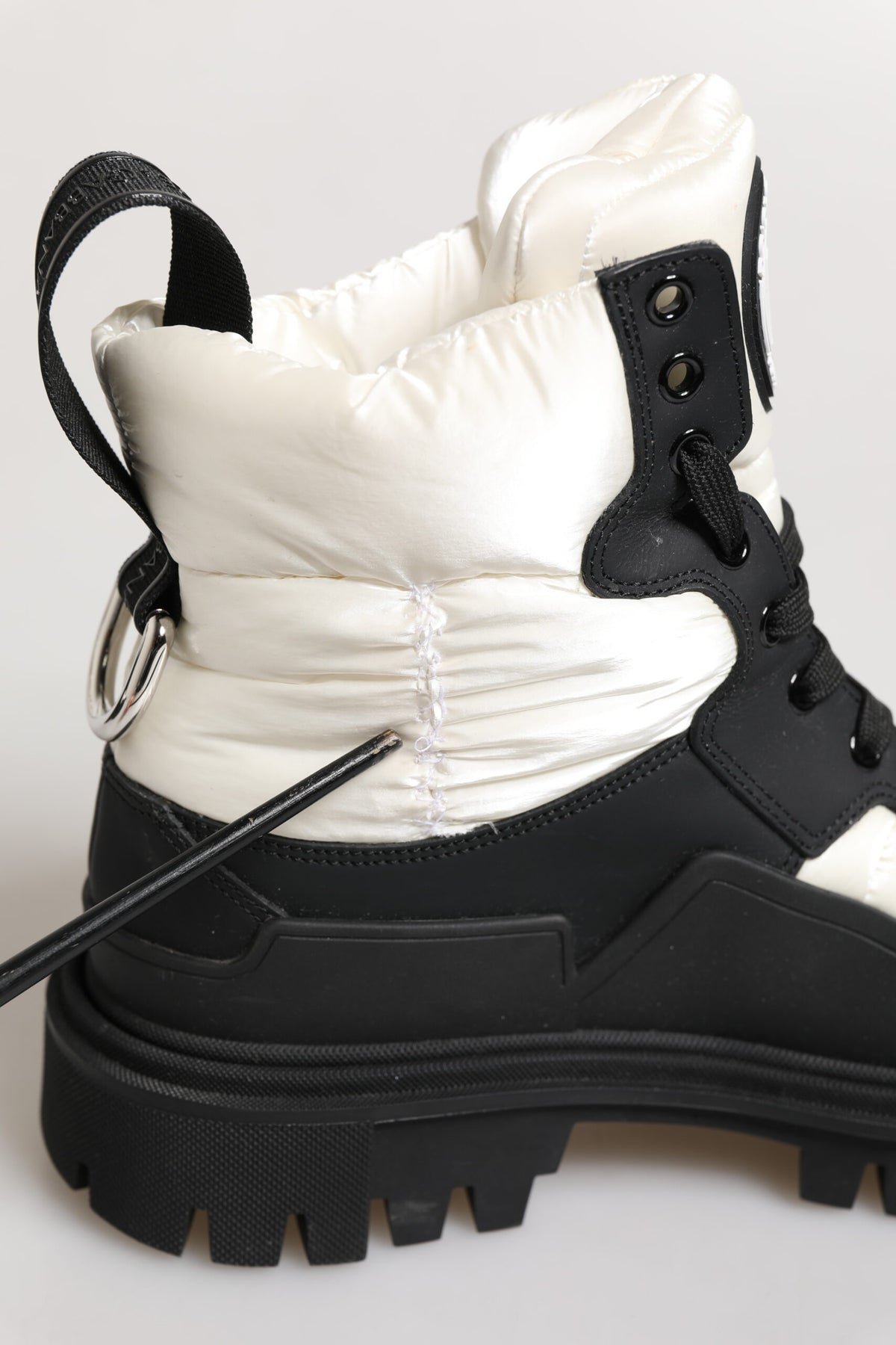 Experience the allure of Dolce & Gabbana's Black White Padded Lace Up Short Boots, where exquisite craftsmanship meets timeless elegance for the discerning individual.
