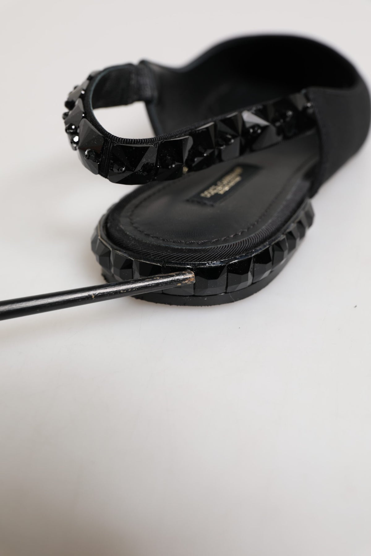 Elevate your elegance with Dolce & Gabbana's Black Crystal Charmeuse Slingback Shoes, where sumptuous silk and exquisite craftsmanship redefine luxury for the discerning individual.