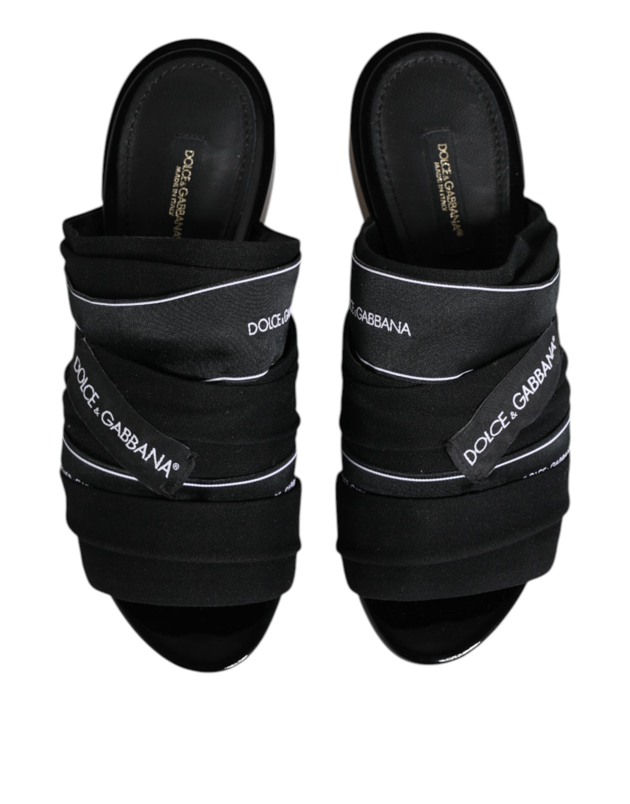 Experience the allure of Dolce & Gabbana Black Slides, crafted from premium fabric and leather, embodying timeless sophistication for the discerning individual.