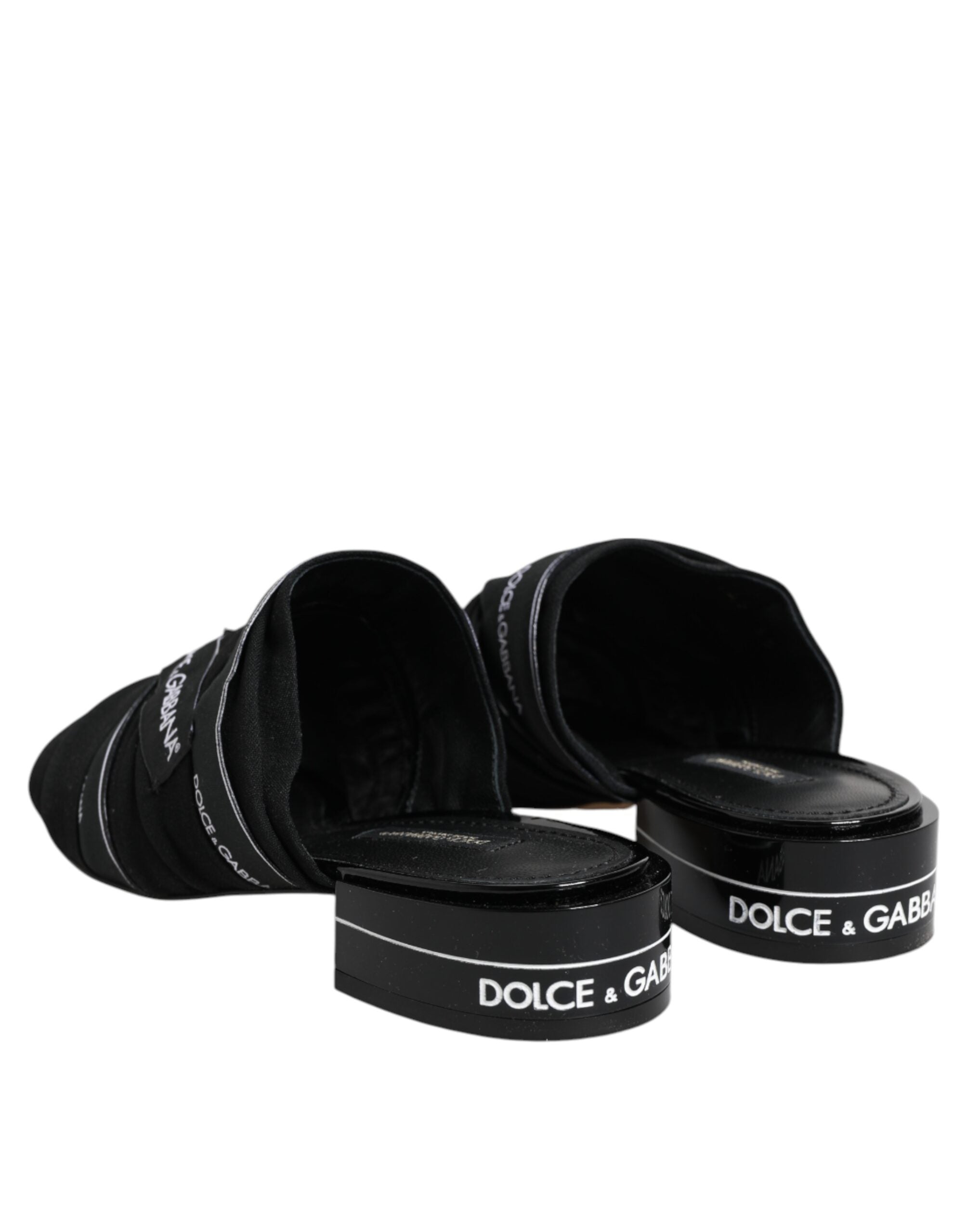 Experience the allure of Dolce & Gabbana Black Slides, crafted from premium fabric and leather, embodying timeless sophistication for the discerning individual.