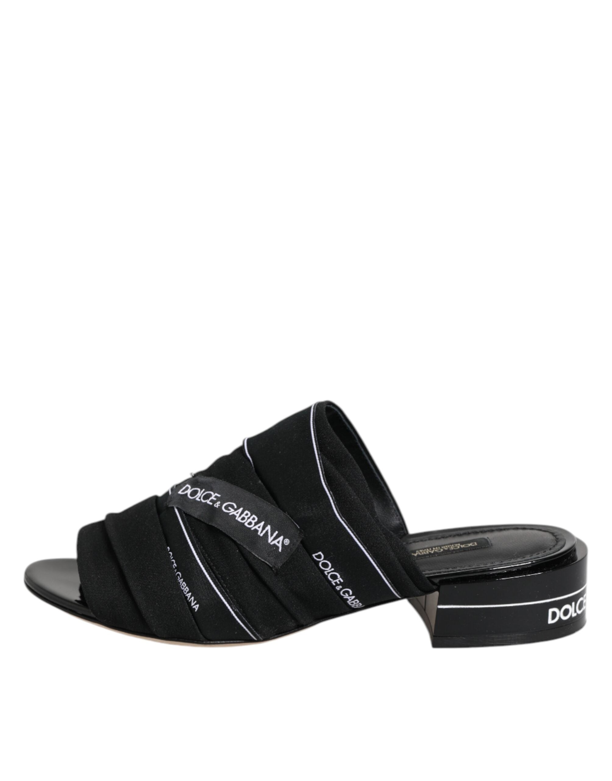 Elevate your style with Dolce & Gabbana Black Slides, where luxurious fabric and leather craftsmanship meet timeless elegance for the discerning individual.
