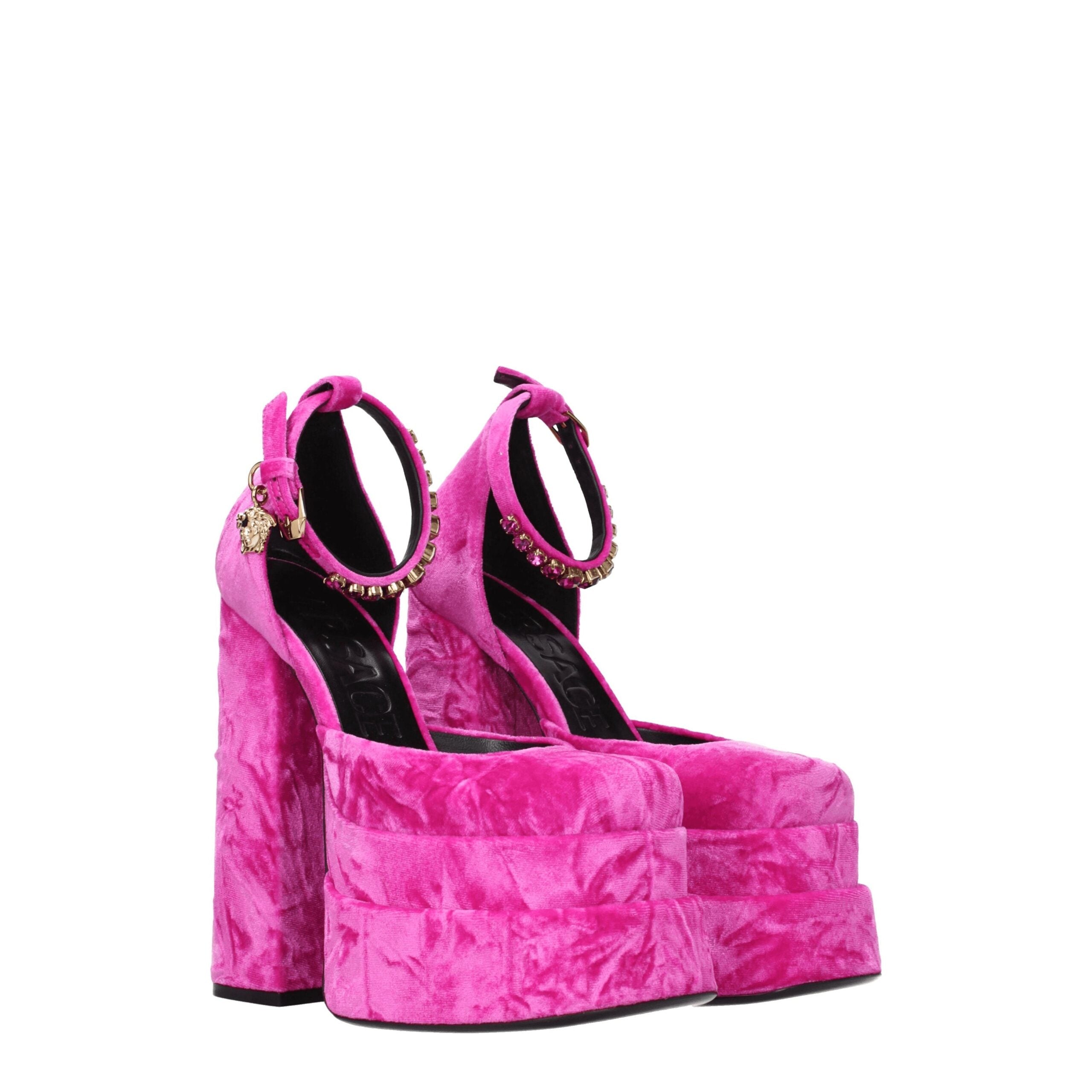 Elevate your evening allure with Versace Pink Velvet Platform Sandals, a luxurious fusion of plush fuchsia velvet and radiant rhinestones, perfect for any sophisticated occasion.