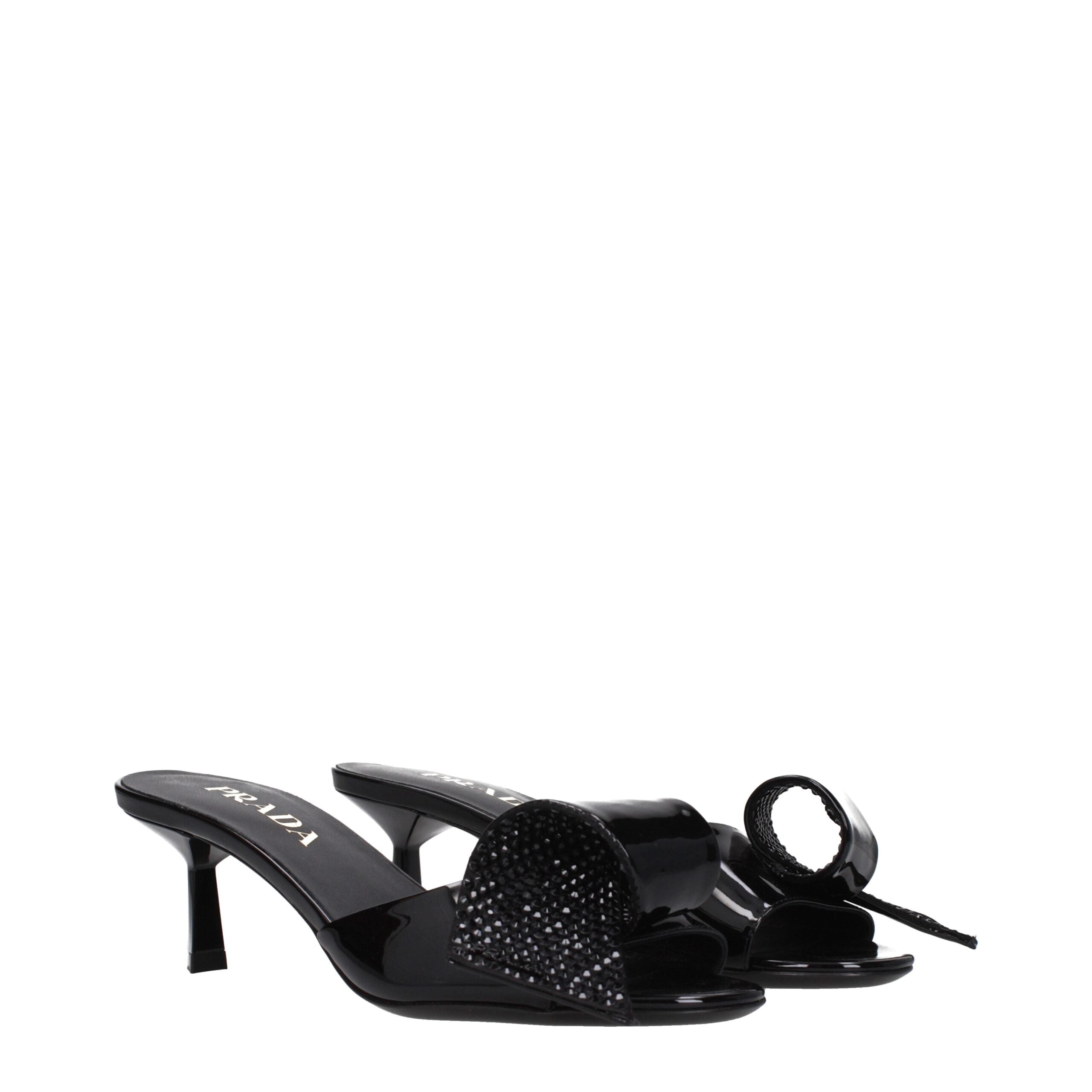 Step into sophistication with Prada Black Leather Sandals, crafted from luxurious patent leather, embodying timeless elegance for the discerning individual.