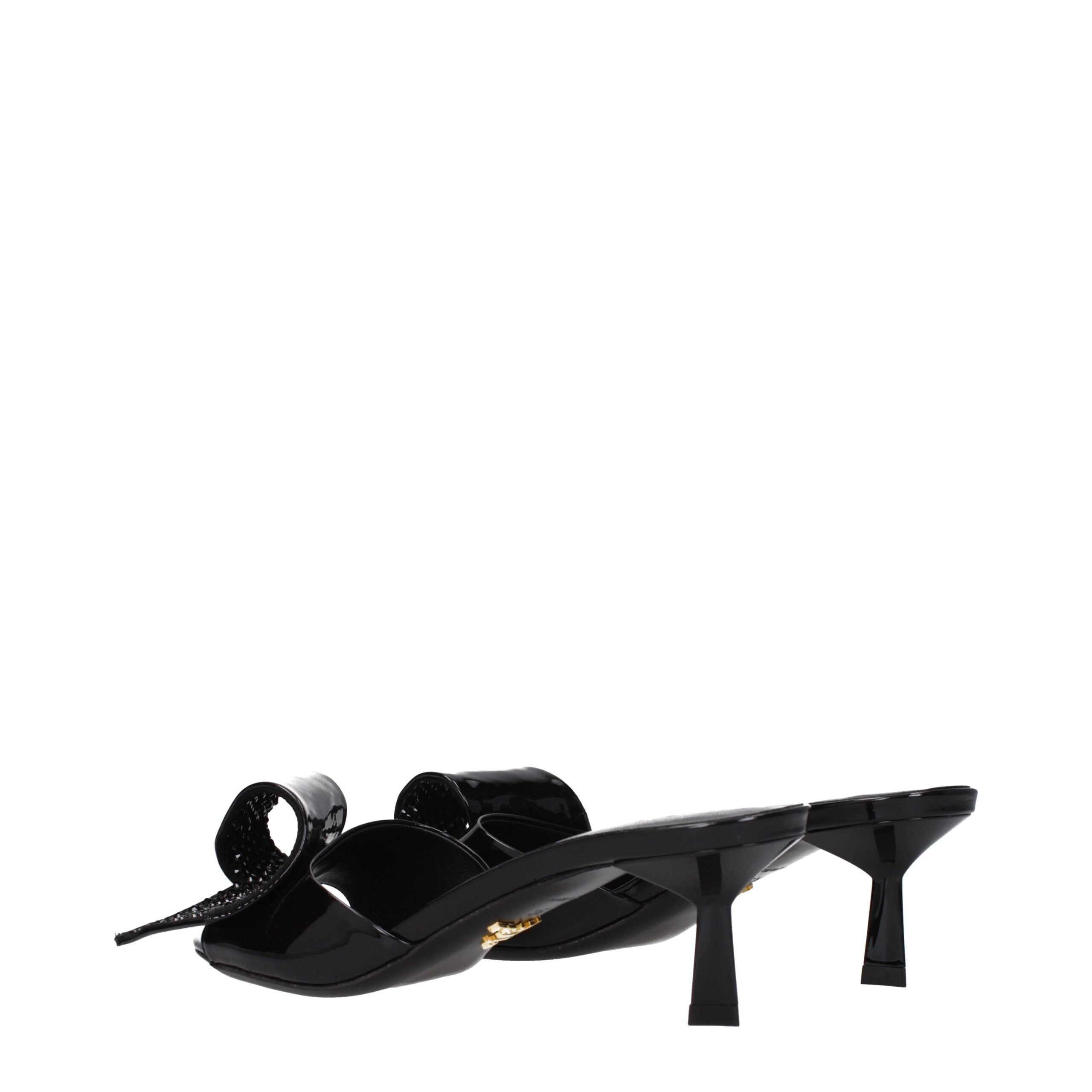 Indulge in the exquisite allure of Prada Black Leather Sandals, crafted from luxurious patent leather, embodying sophistication and elegance for every occasion.