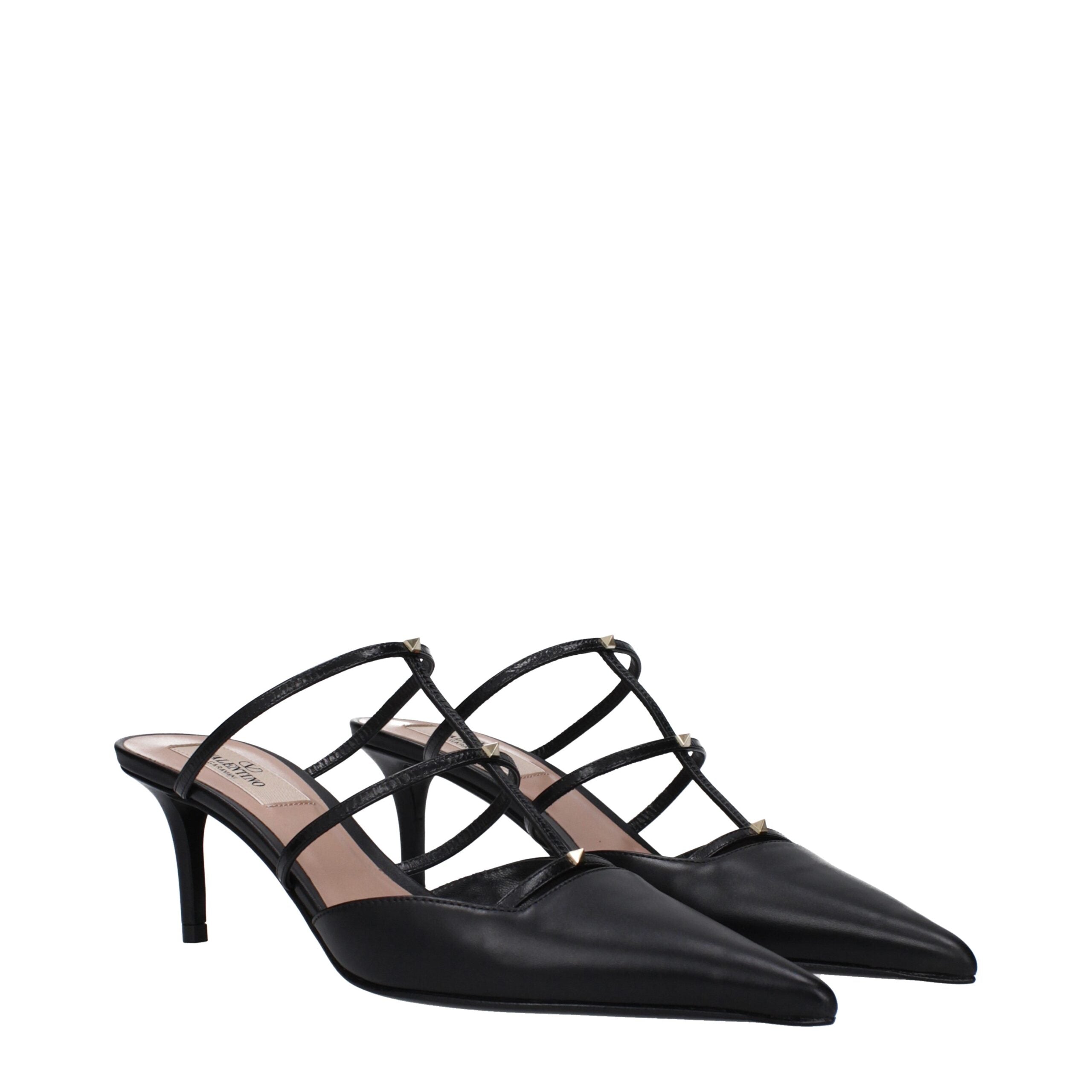 Indulge in the exquisite Valentino Garavani Black Leather Flat Sandals, where luxurious craftsmanship meets timeless elegance, perfect for the discerning connoisseur.