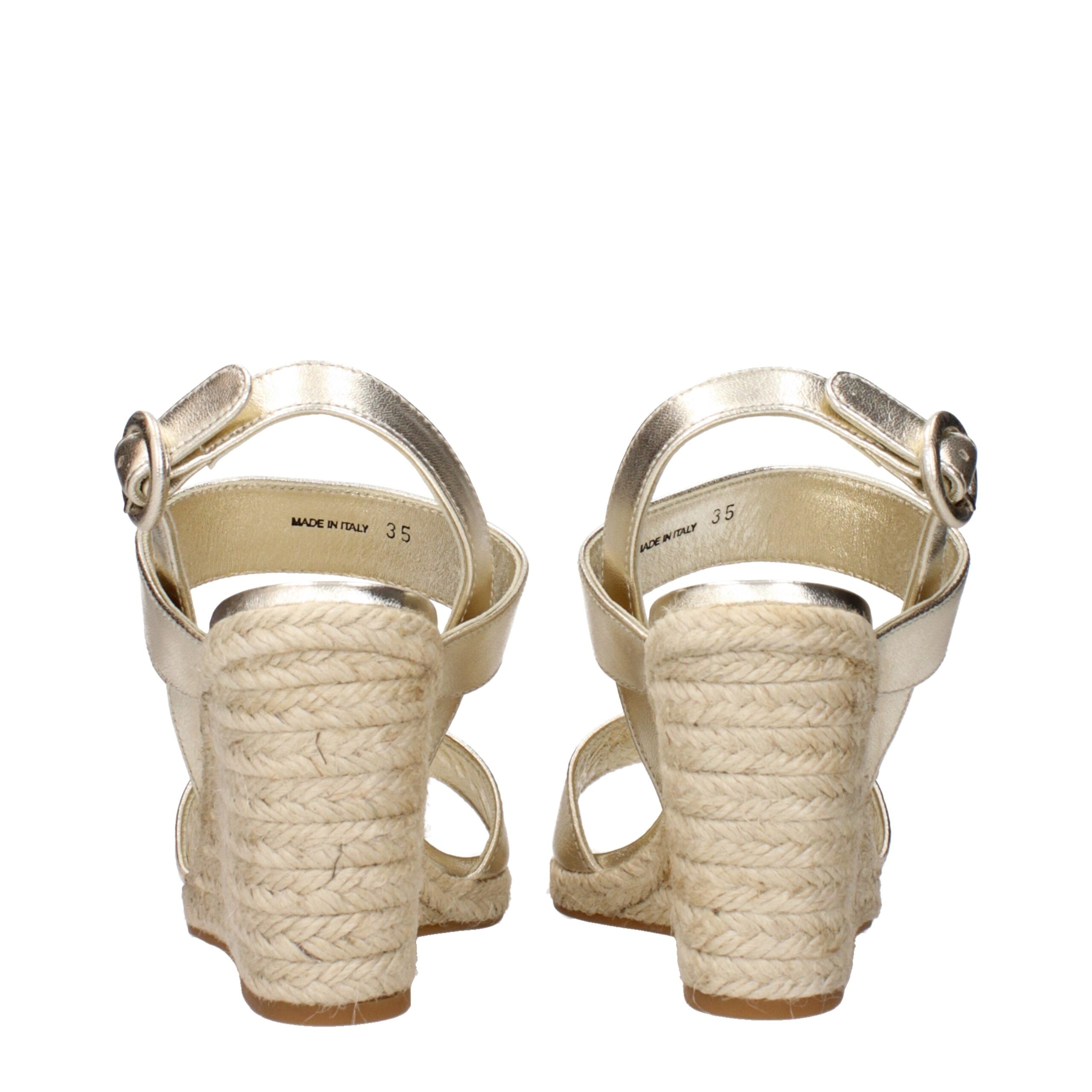 Elevate your style with Prada Gold Leather Wedge Sandals, a luxurious blend of vintage allure and impeccable craftsmanship, perfect for the discerning individual.