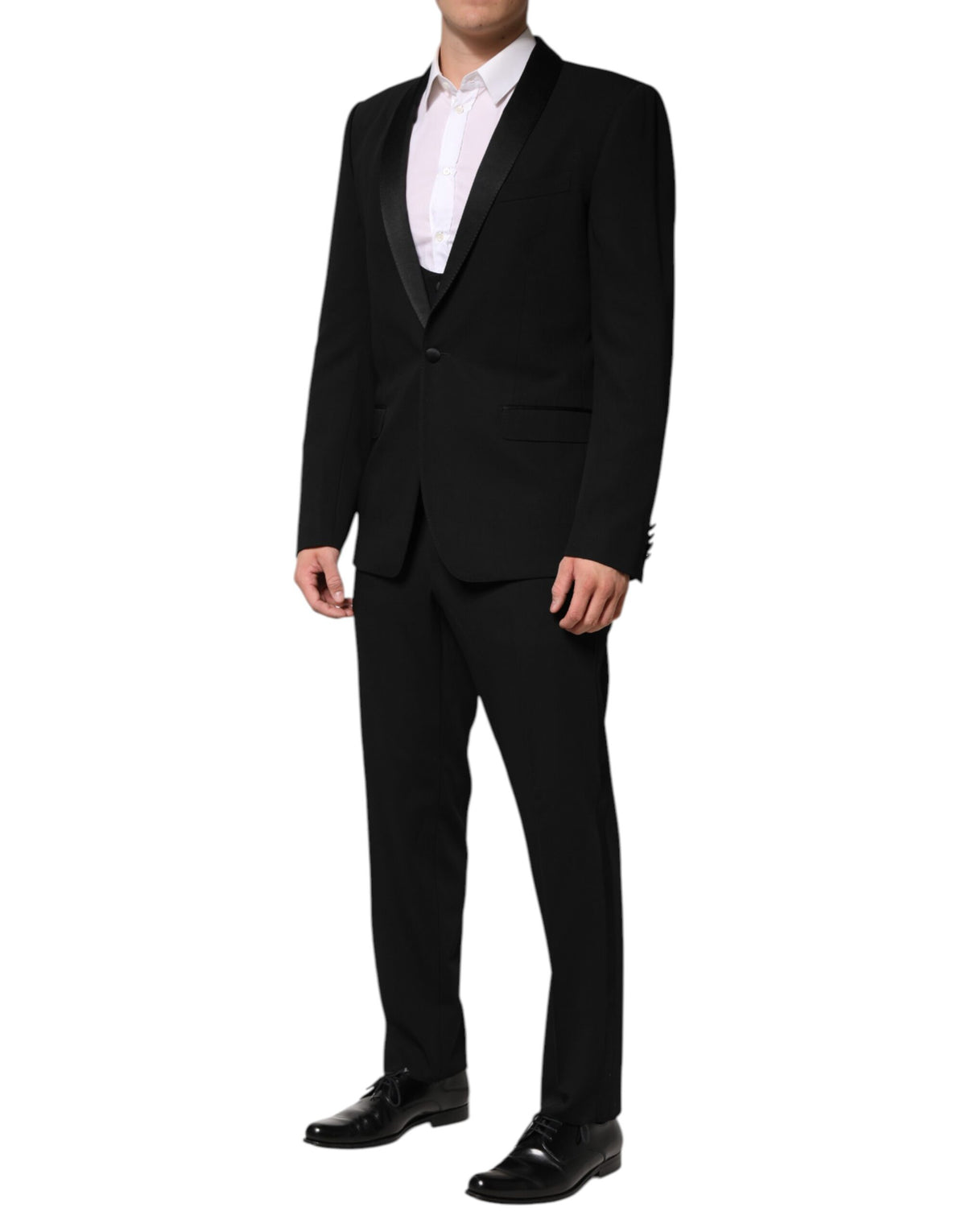 Experience the allure of the Dolce & Gabbana Black Wool 3 Piece Suit, a masterpiece of artisanal elegance crafted from luxurious virgin wool and silk, perfect for the discerning individual.