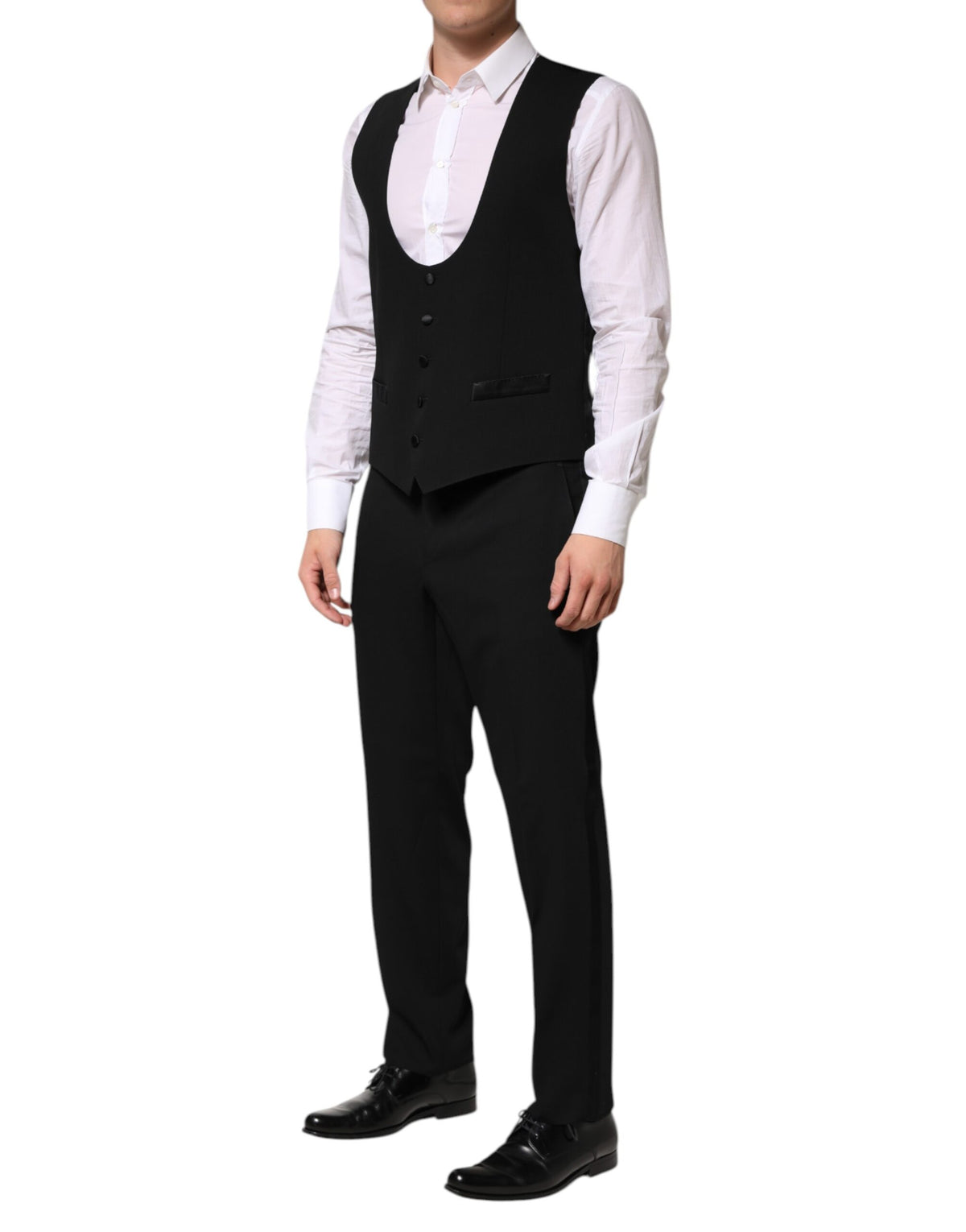 Elevate your wardrobe with the Dolce & Gabbana Black Wool 3 Piece Suit, a masterpiece of artisanal craftsmanship and luxurious materials, perfect for any sophisticated occasion.