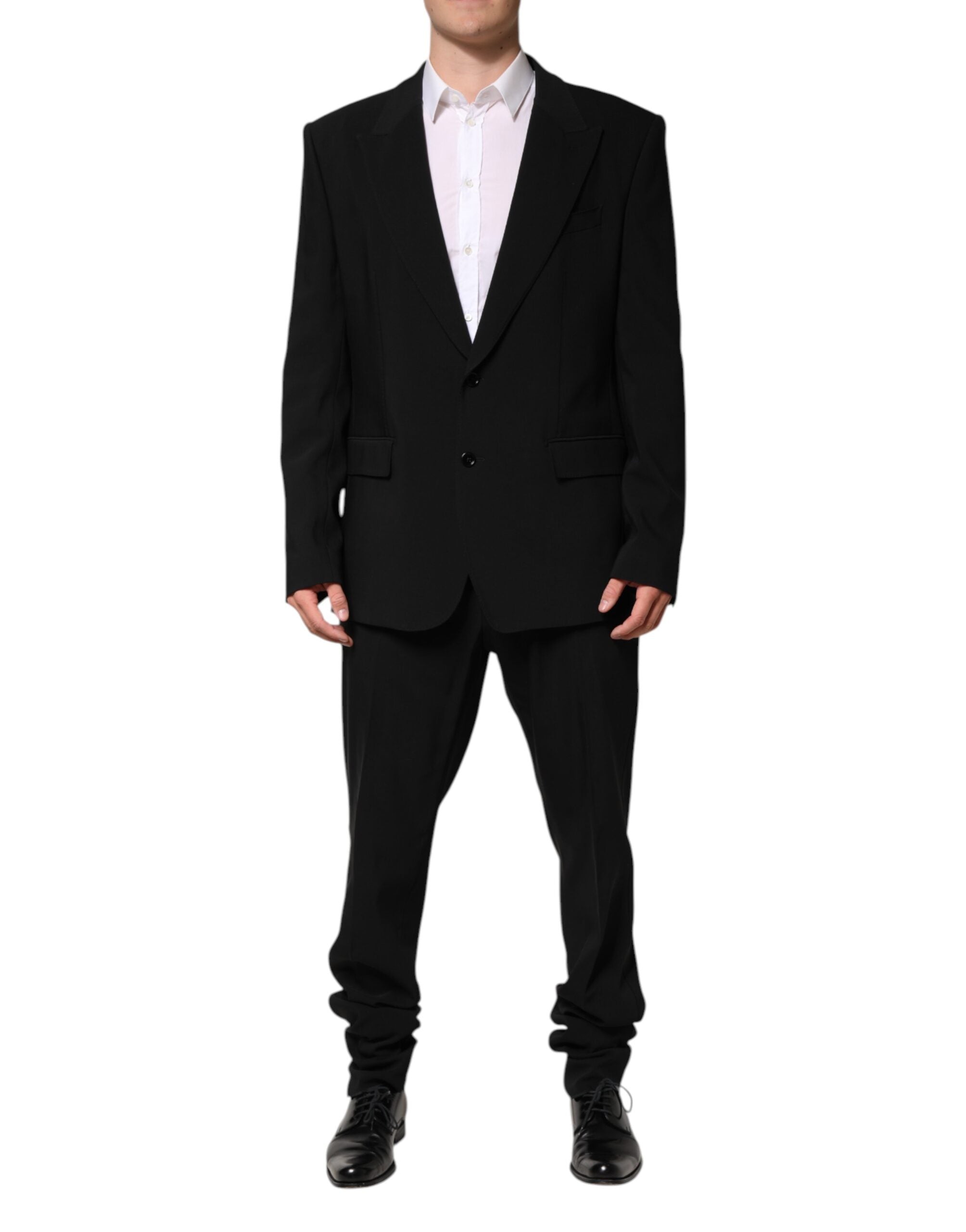 Discover the Dolce & Gabbana Black Cotton Single Breasted Suit, a masterpiece of Italian craftsmanship, blending luxurious materials with timeless elegance for the discerning individual.
