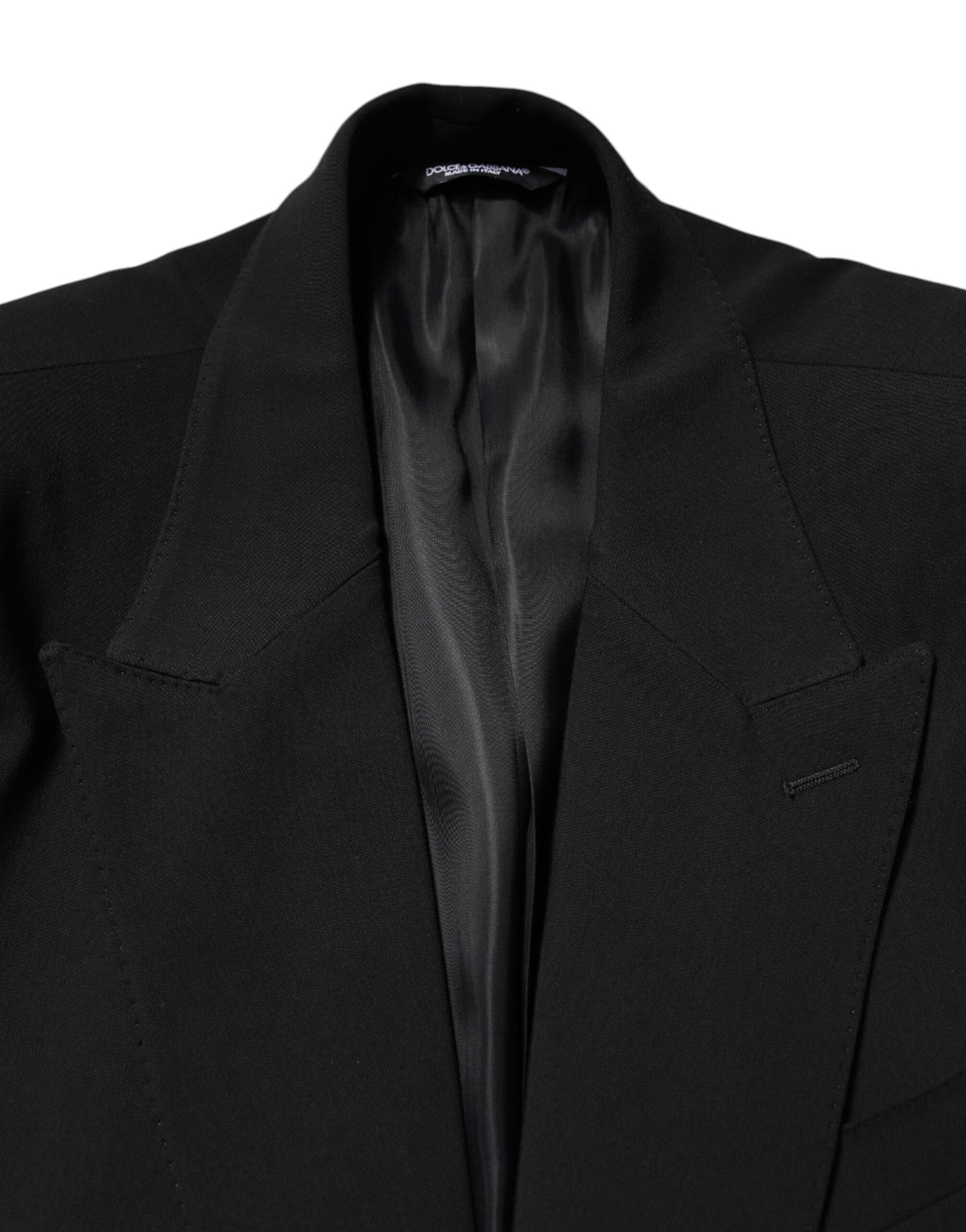 Discover the exquisite Dolce & Gabbana Black Cotton Single Breasted Suit, a masterpiece of Italian craftsmanship that embodies timeless elegance and sophisticated allure.