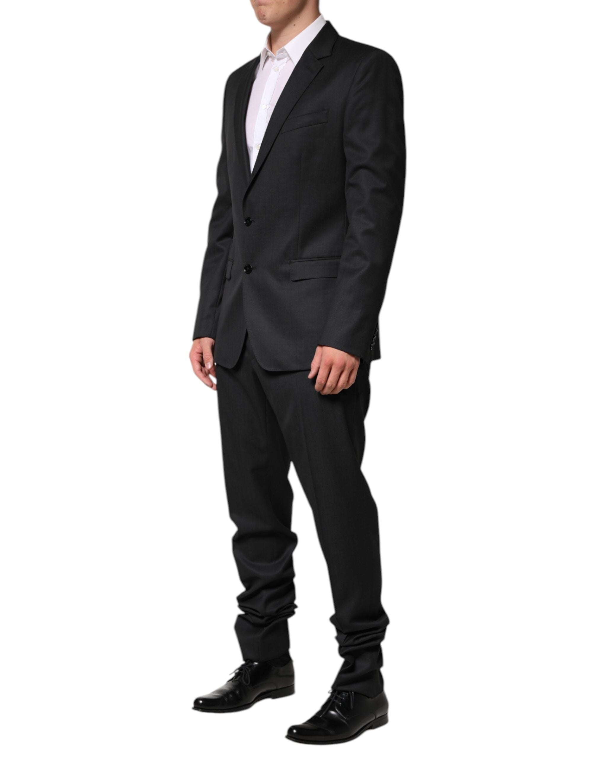 Experience the allure of the Dolce & Gabbana Dark Gray Wool Suit, a masterpiece of Italian craftsmanship in luxurious virgin wool, perfect for timeless elegance.