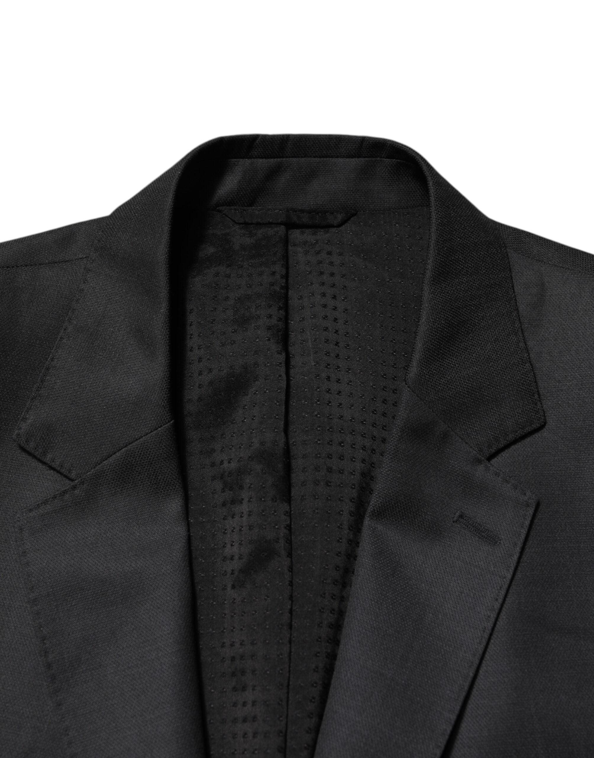 Elevate your style with the Dolce & Gabbana Dark Gray Wool Suit, a masterpiece of Italian craftsmanship in luxurious virgin wool, perfect for the discerning individual.