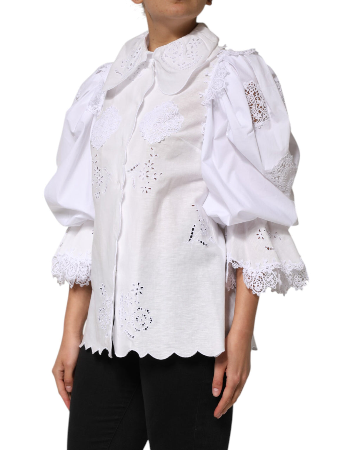 Indulge in the exquisite elegance of the Dolce & Gabbana White Ruffled Lace Embellished Blouse, a masterpiece of Italian craftsmanship that elevates your sophisticated wardrobe.