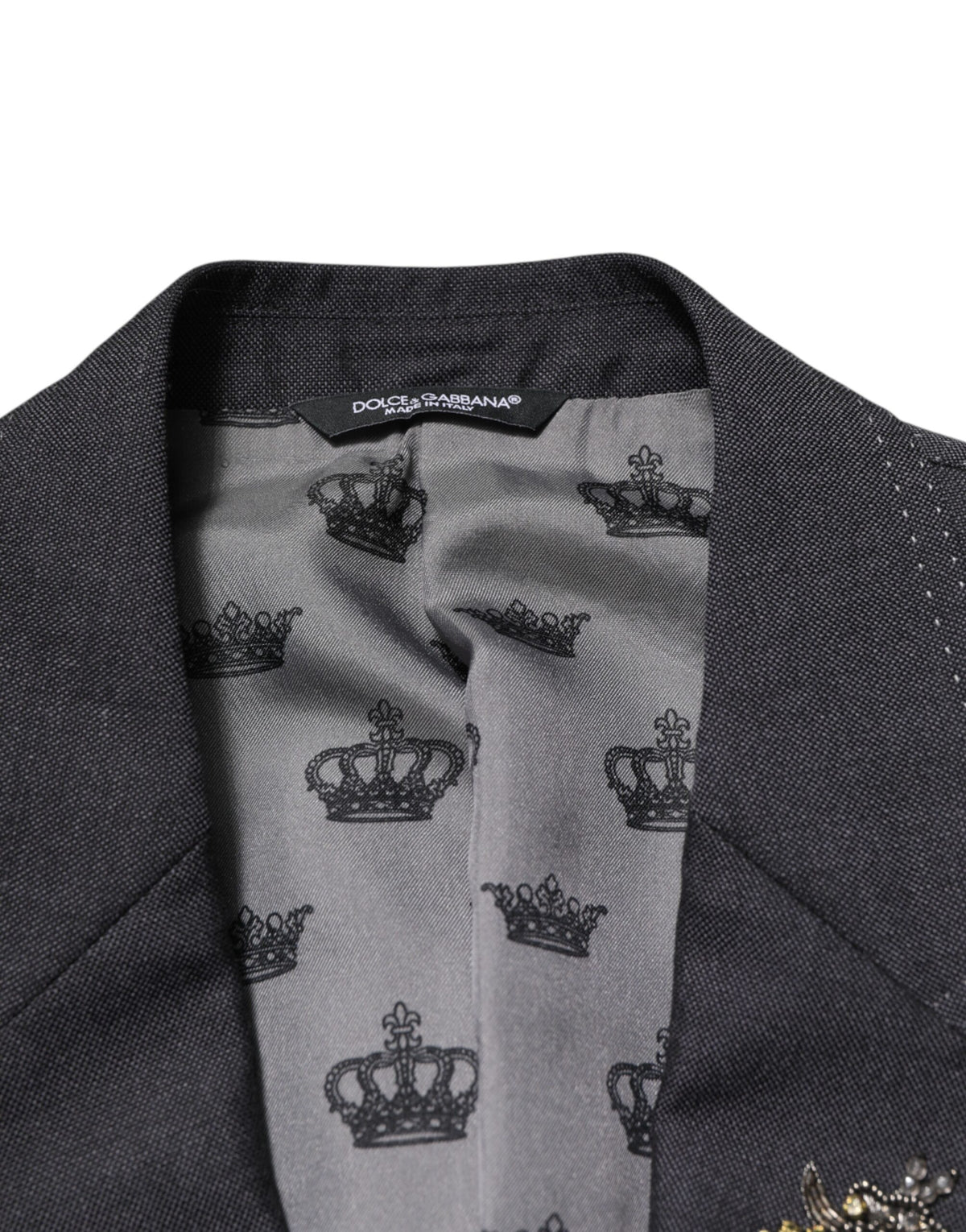 Experience the exquisite craftsmanship of the Dolce & Gabbana Dark Gray Bee Embroidery Wool Coat Blazer, where luxurious materials meet timeless elegance for the discerning individual.