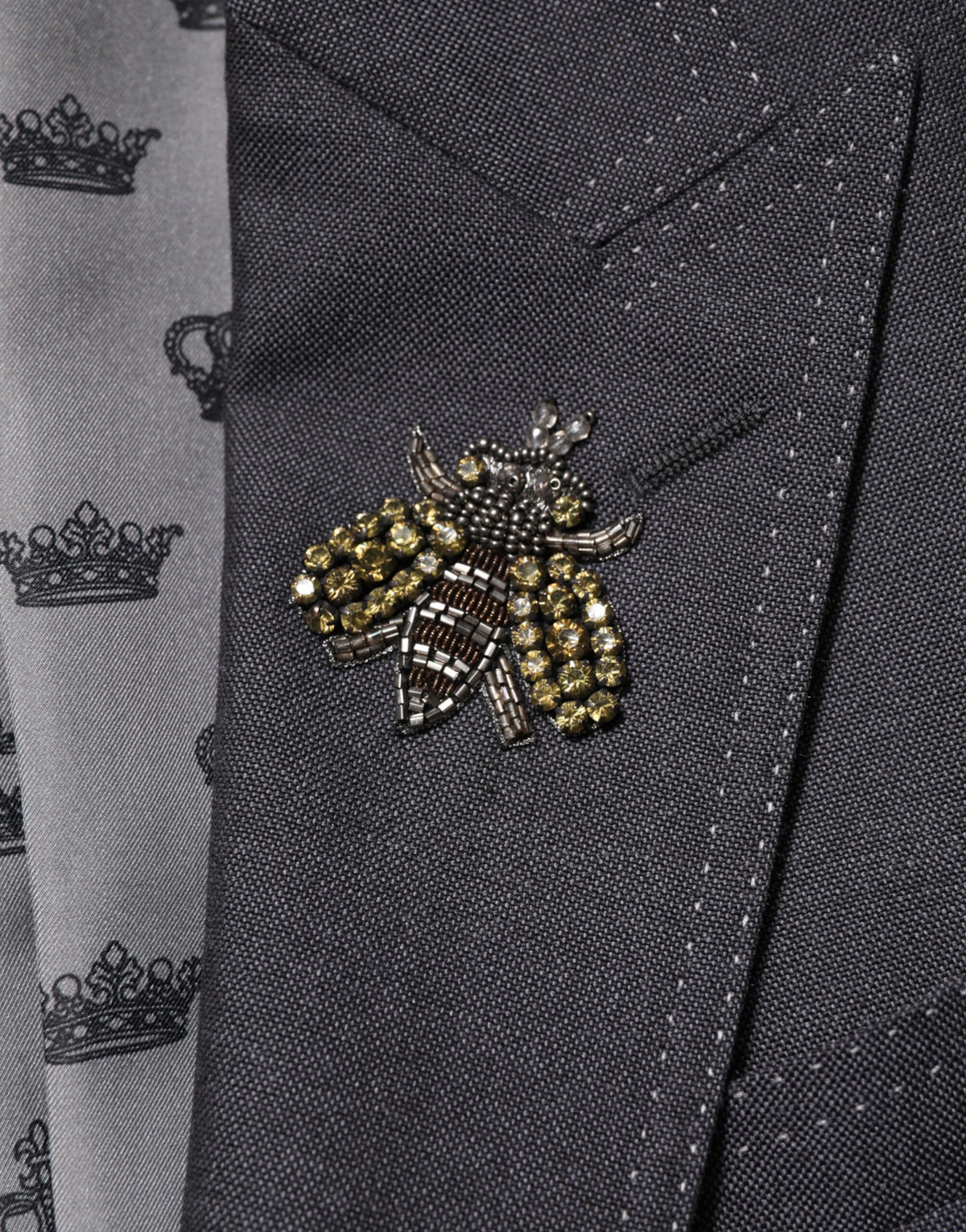 Indulge in the exquisite luxury of the Dolce & Gabbana Dark Gray Bee Embroidery Wool Coat Blazer, where meticulous craftsmanship meets timeless elegance for the discerning individual.