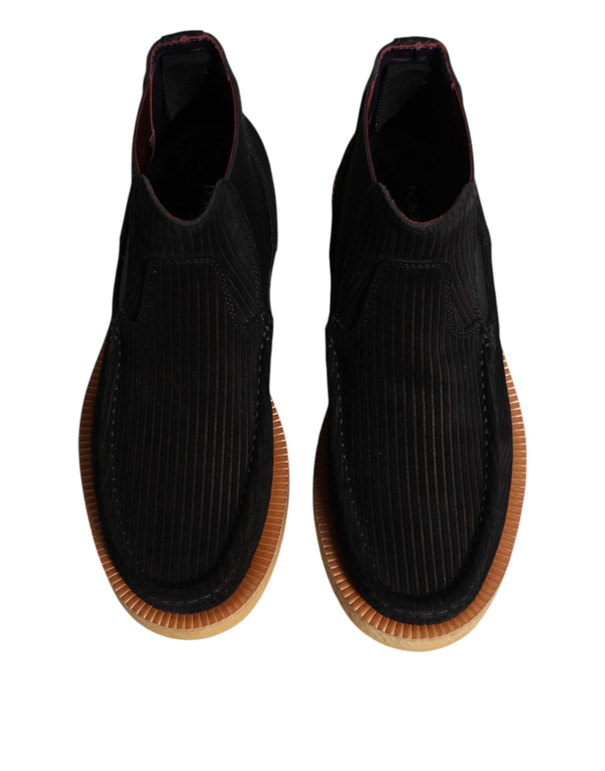 Indulge in the luxurious allure of Dolce & Gabbana's black calf suede slip-on ankle boots, where exquisite craftsmanship meets timeless elegance for the discerning individual.