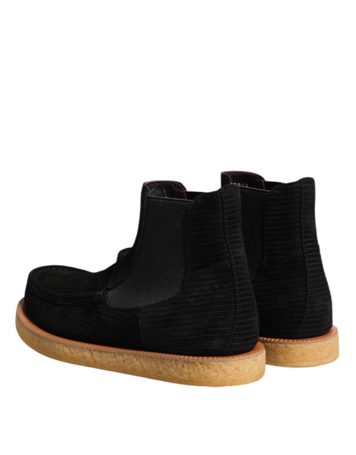 Indulge in the exquisite craftsmanship of Dolce & Gabbana's black calf suede slip-on ankle boots, a timeless blend of luxury and sophistication for the discerning individual.