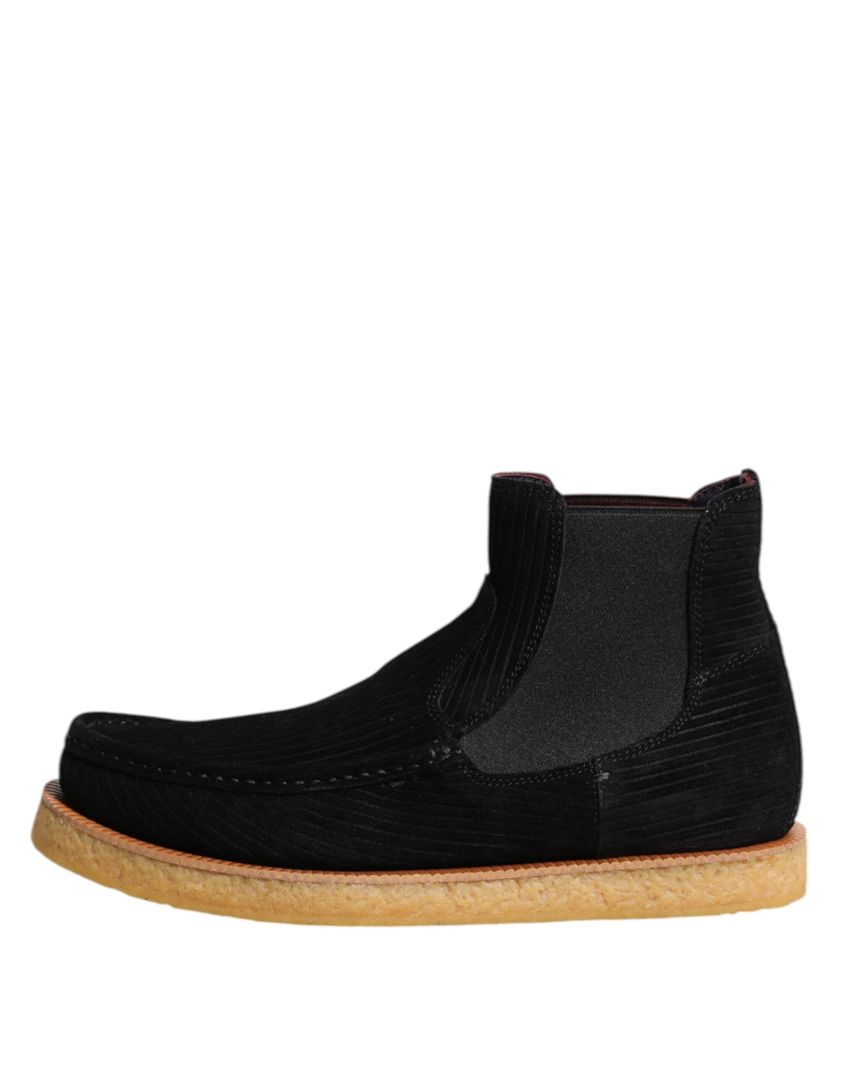 Indulge in the exquisite craftsmanship of Dolce & Gabbana's black calf suede slip-on ankle boots, where timeless luxury meets effortless sophistication for the discerning individual.