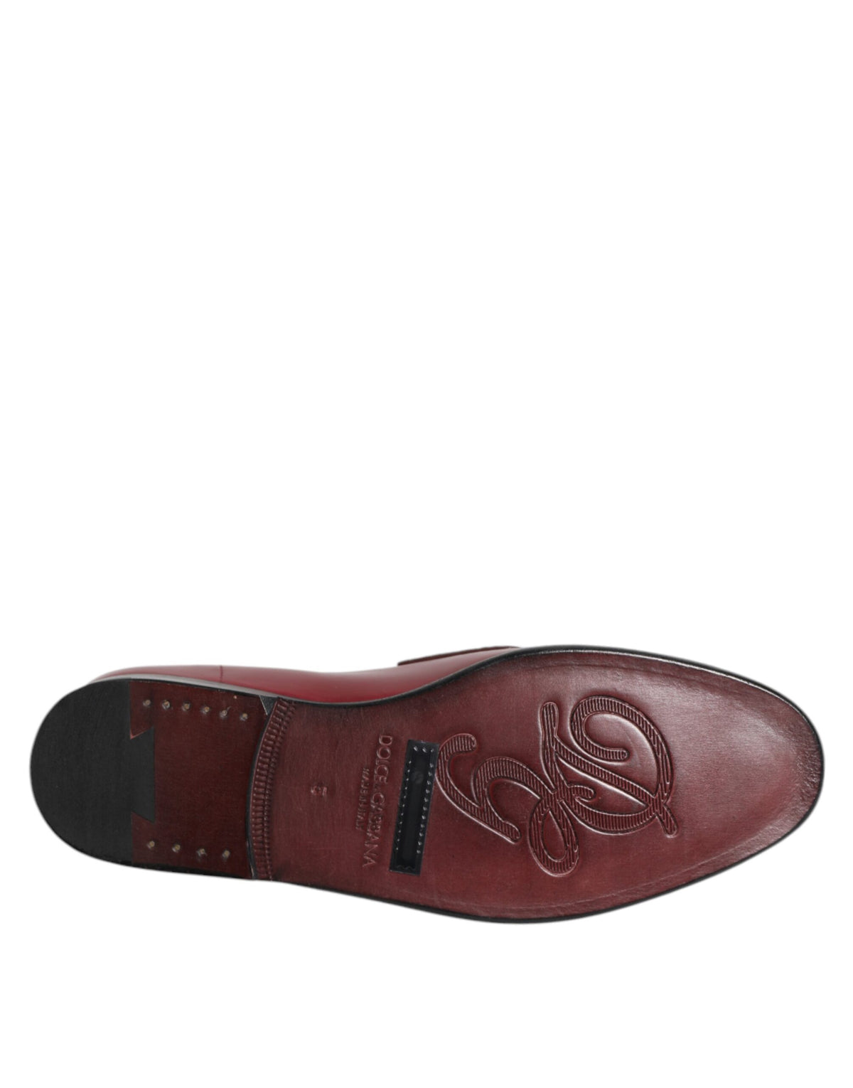 Step into the realm of sophistication with Dolce & Gabbana's Burgundy Leather Formal Slip On Shoes, crafted from luxurious calfskin and caiman leather, embodying timeless elegance and exquisite craftsmanship.