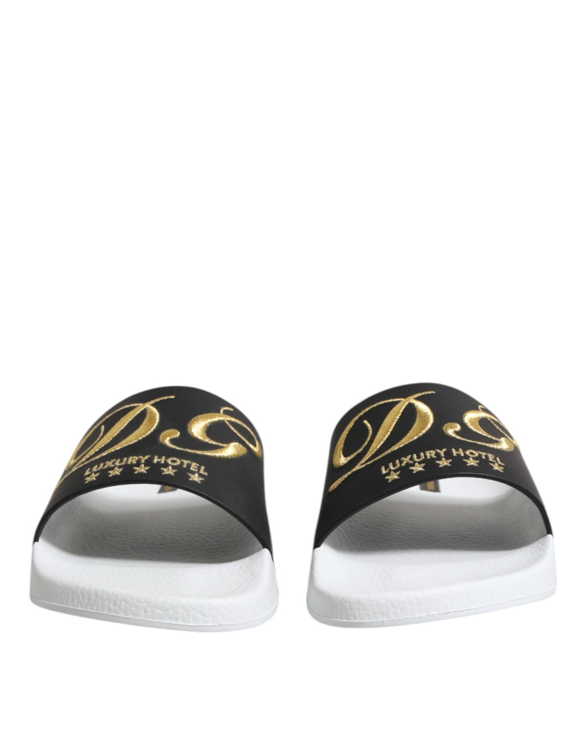 Experience the allure of Dolce & Gabbana White Black Leather Sandals, crafted from sumptuous calfskin leather, embodying artisanal luxury for the discerning individual.