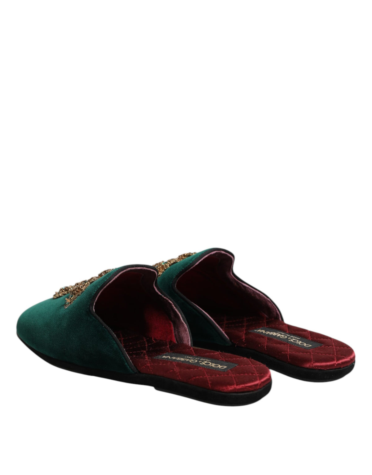 Elevate your style with Dolce & Gabbana's Green Velvet Cross Embellished Slippers, where exquisite craftsmanship meets luxurious materials for an unparalleled fashion statement.