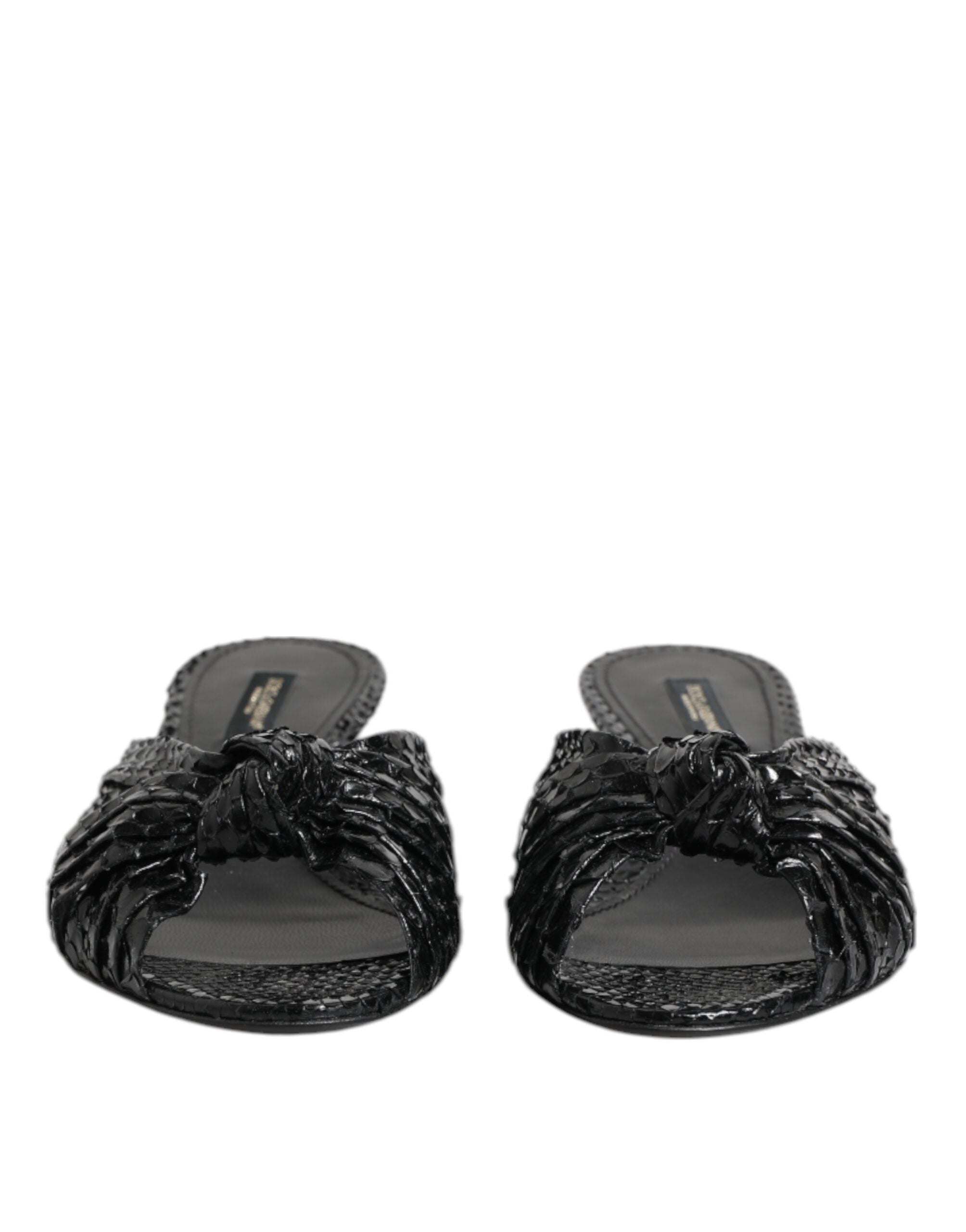 Experience the allure of Dolce & Gabbana's Black Leather Heels Slides, crafted from python leather, epitomizing luxury and sophistication for the discerning individual.