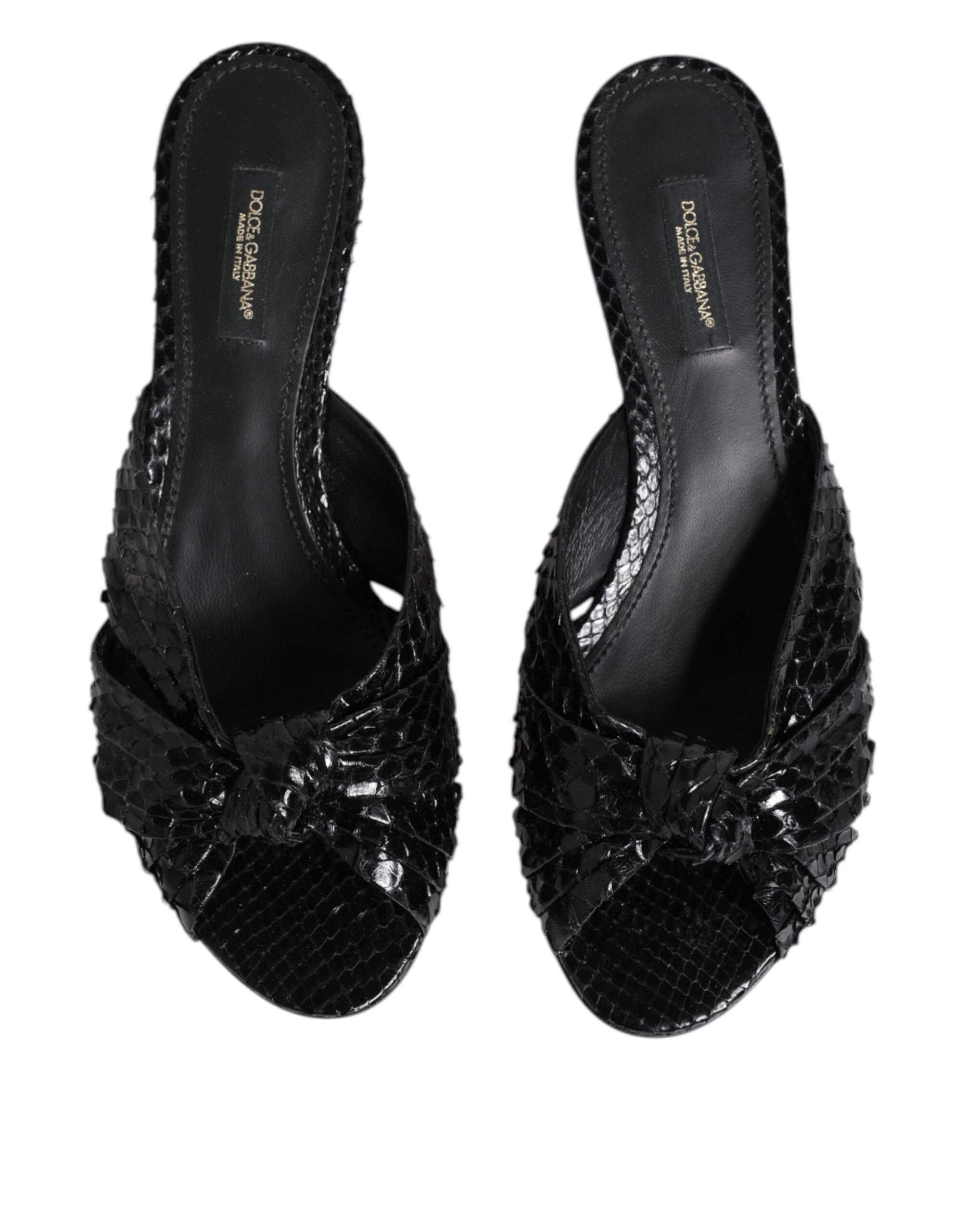 Experience the allure of Dolce & Gabbana's Black Leather Heels Slides, crafted from luxurious python leather for a sophisticated statement in every stride.
