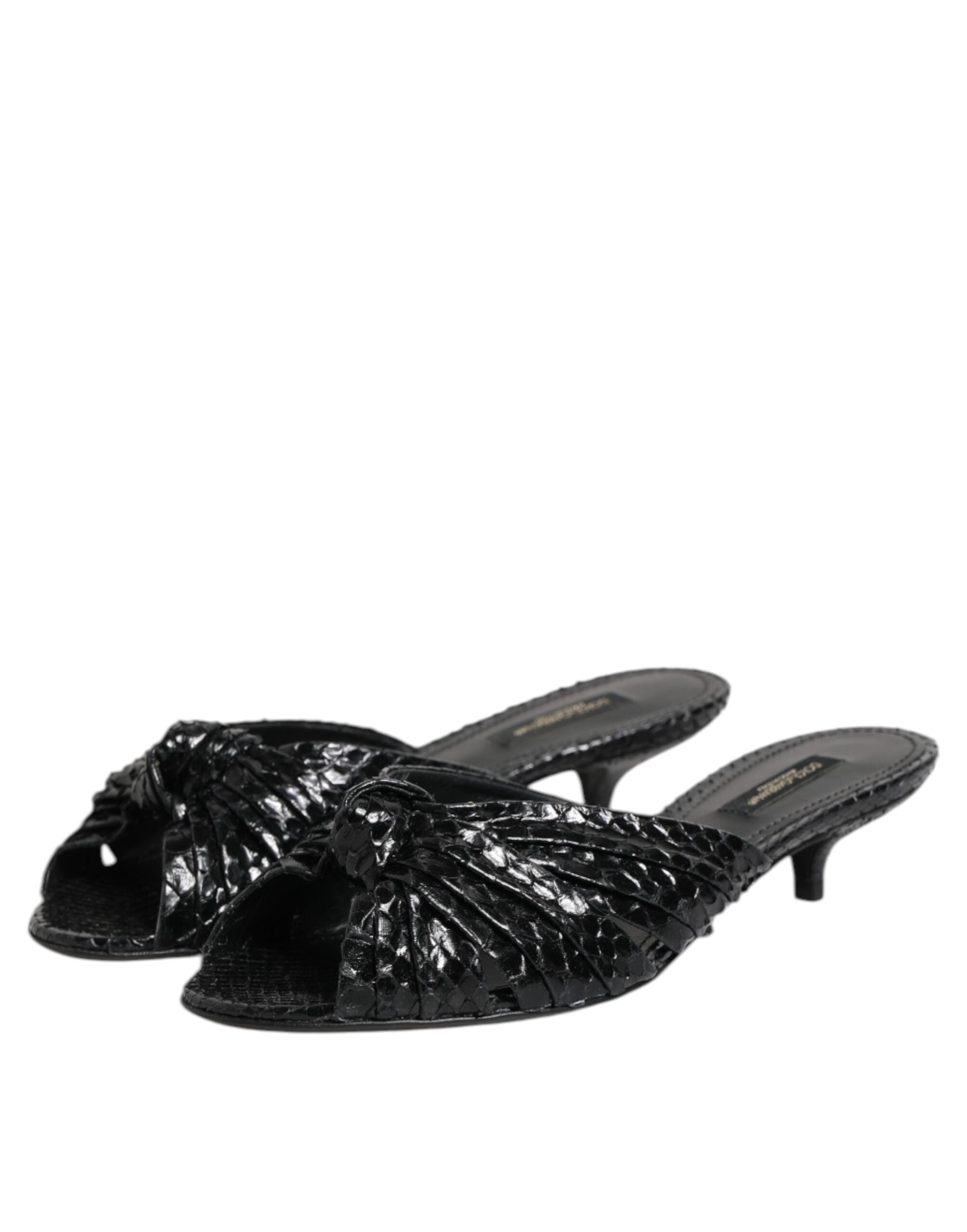 Elevate your elegance with Dolce & Gabbana Black Leather Heels Slides, crafted from sumptuous python leather, embodying artisanal luxury for the discerning individual.