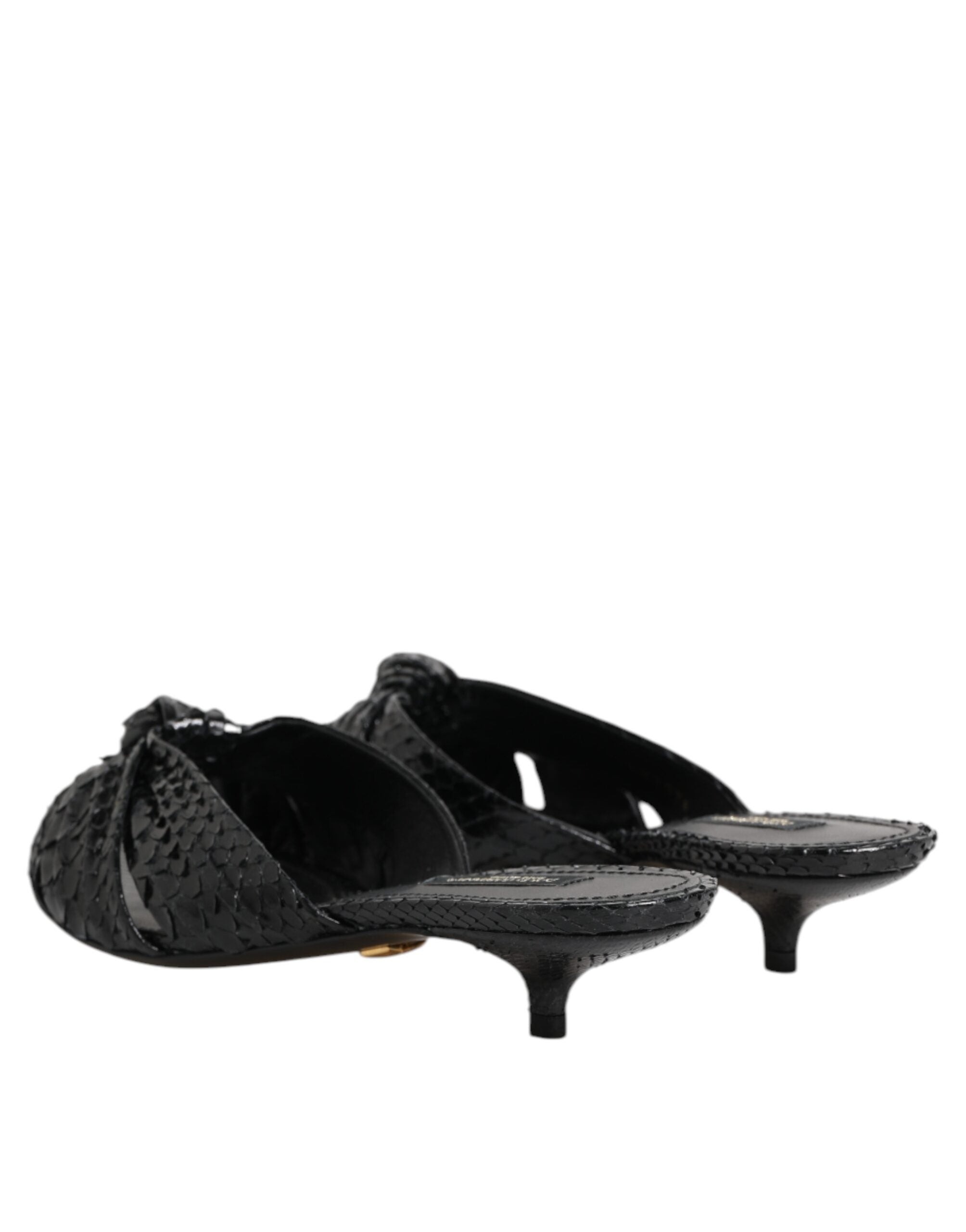 Elevate your style with Dolce & Gabbana's Black Leather Heels Slides, crafted from luxurious python leather, embodying sophistication and timeless elegance.