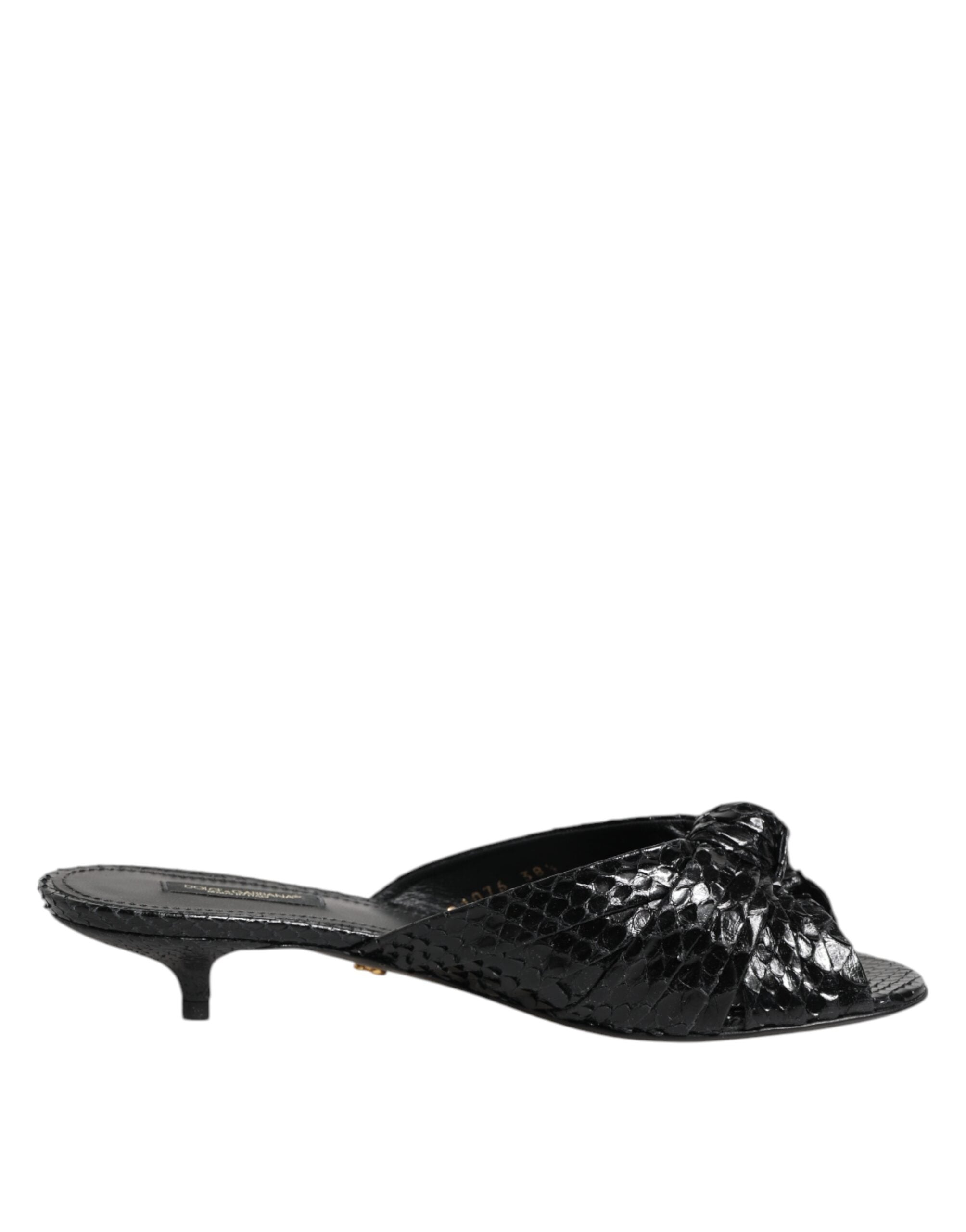 Experience the allure of Dolce & Gabbana's Black Leather Heels Slides, crafted from sumptuous python leather, embodying timeless elegance and artisanal luxury.