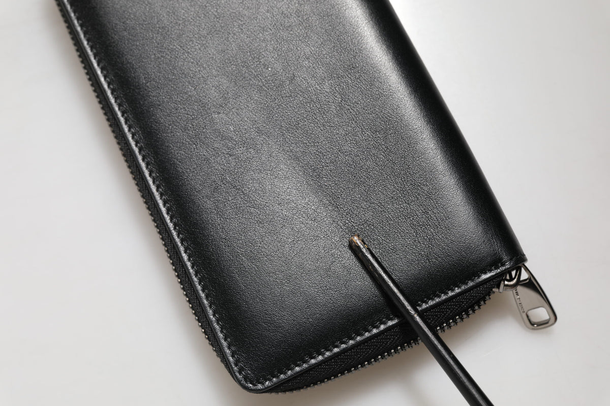 Indulge in the exquisite Dolce & Gabbana Black Leather DG Plaque Zip Around Continental Wallet, a testament to Italian craftsmanship and timeless elegance, perfect for the discerning individual.