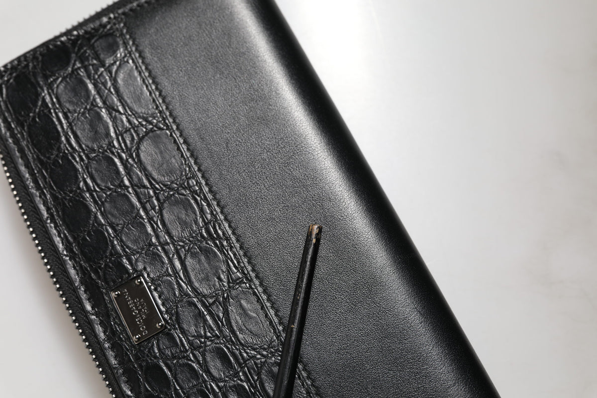 Indulge in the exquisite craftsmanship of the Dolce & Gabbana Black Leather DG Plaque Zip Around Continental Wallet, a timeless accessory that embodies luxury and sophistication.