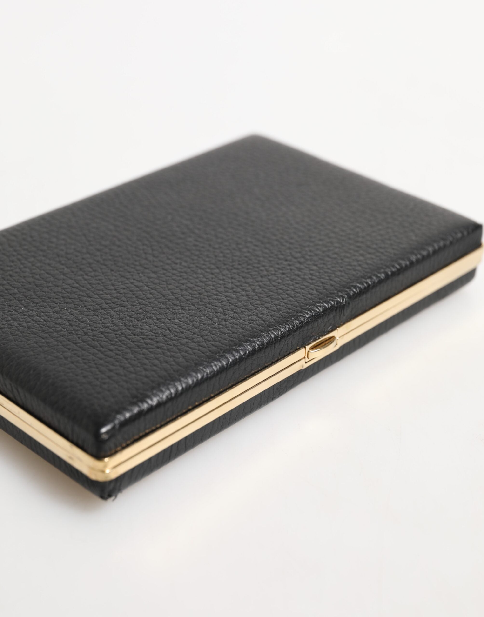 Elevate your evening allure with the Dolce & Gabbana Black Leather Gold Frame Clutch, a luxurious blend of goat leather and exquisite Italian craftsmanship, perfect for sophisticated gatherings.