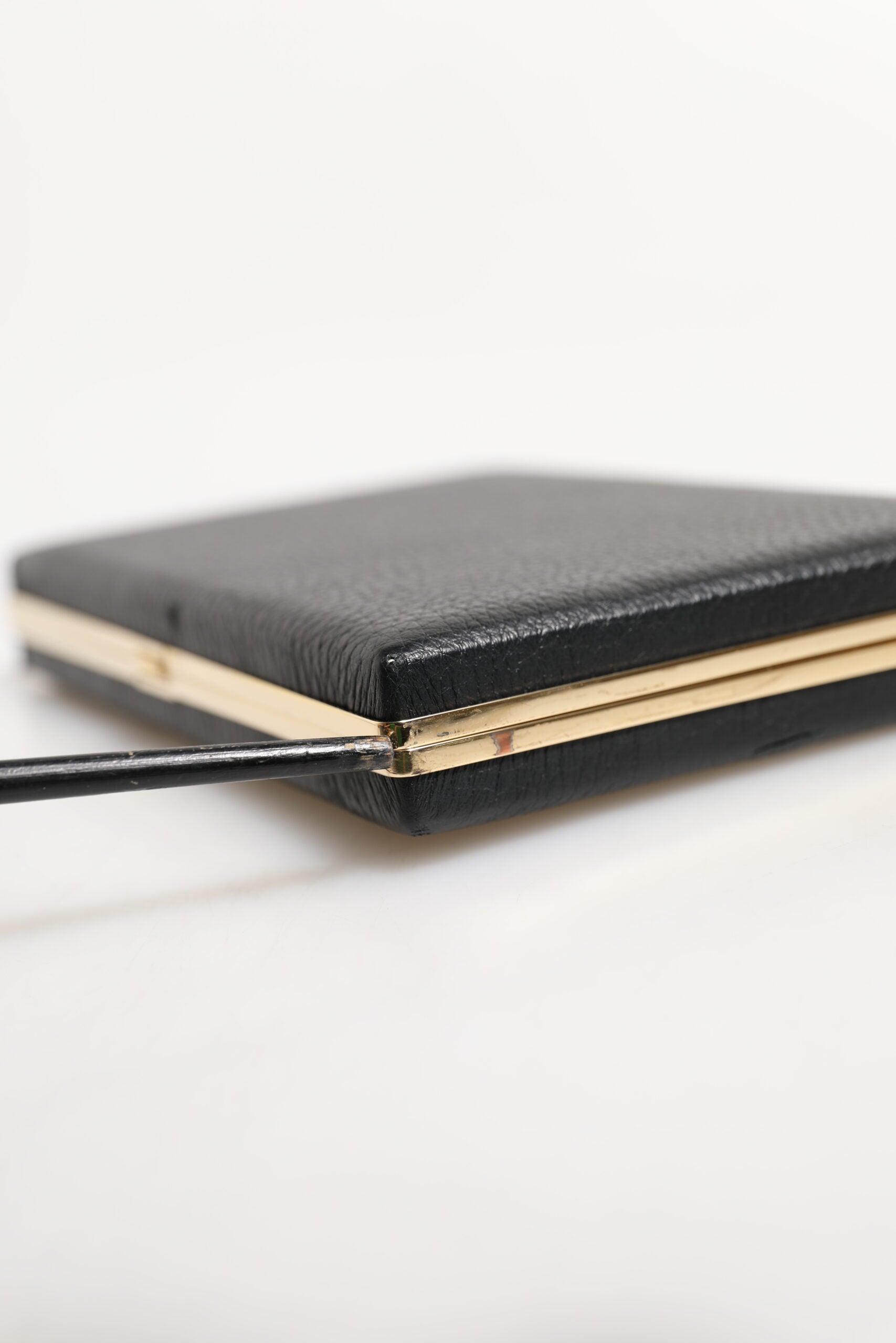 Elevate your evening allure with the Dolce & Gabbana Black Leather Gold Frame Clutch, a luxurious blend of goat leather and exquisite craftsmanship, perfect for any sophisticated occasion.