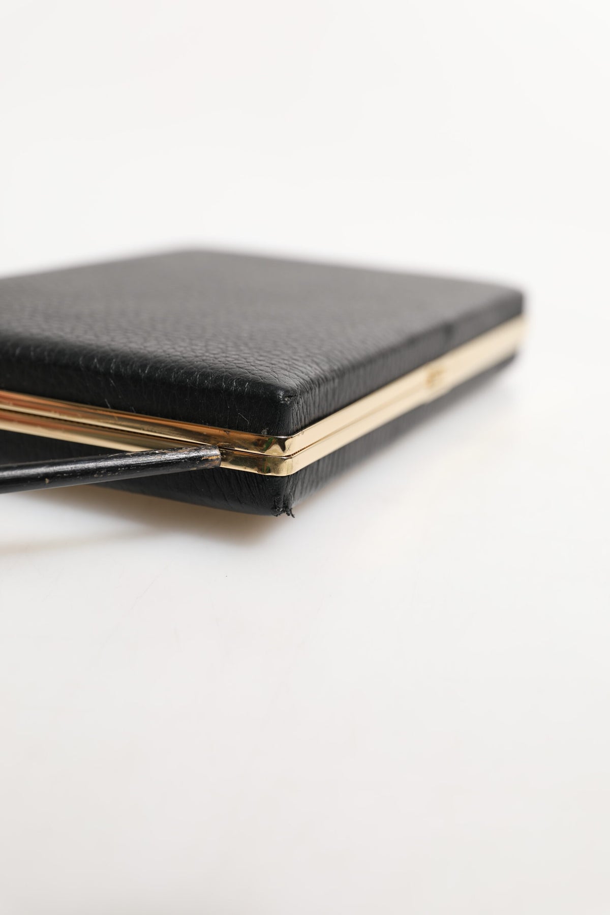 Indulge in the Dolce & Gabbana Black Leather Gold Frame Clutch, a luxurious accessory of exquisite craftsmanship, perfect for elevating your evening allure.