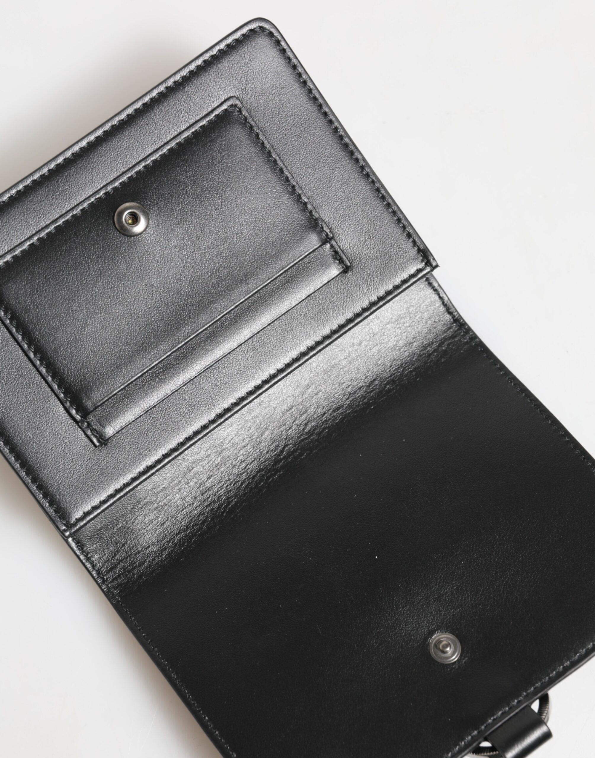 Indulge in the exquisite Dolce & Gabbana Black Leather Crystal Embellished Card Holder Wallet, where luxurious craftsmanship meets timeless elegance, perfect for the discerning individual.