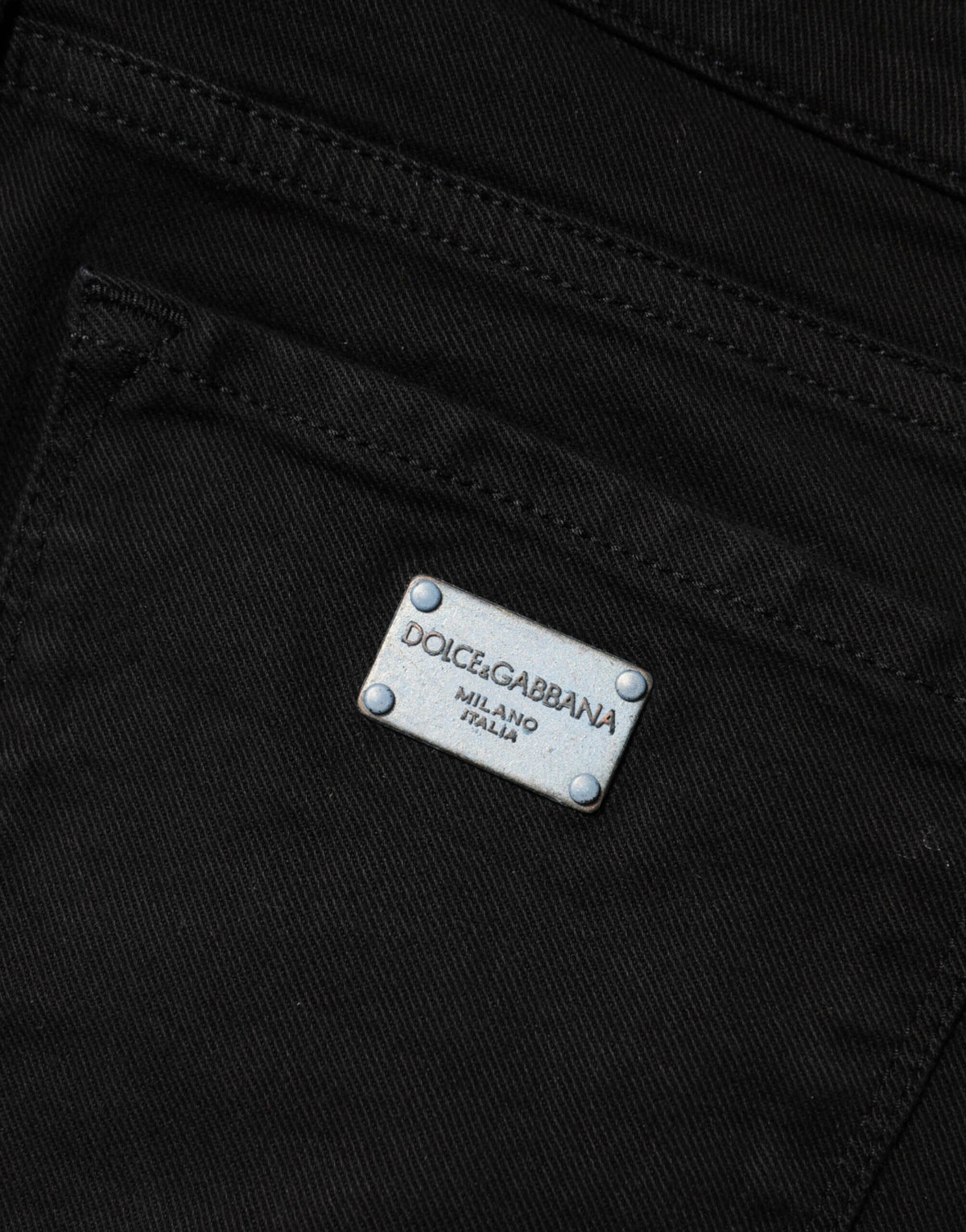 Indulge in the sophistication of Dolce & Gabbana's Black Cotton Skinny Mid Waist Jeans, where exquisite Italian craftsmanship meets timeless elegance for the discerning individual.