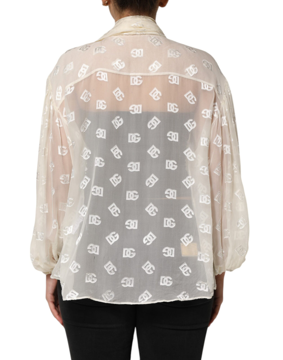 Elevate your wardrobe with the Dolce & Gabbana Off White Logo Monogram Ascot Collar Top, a luxurious blend of silk and viscose that embodies timeless elegance and exquisite craftsmanship.