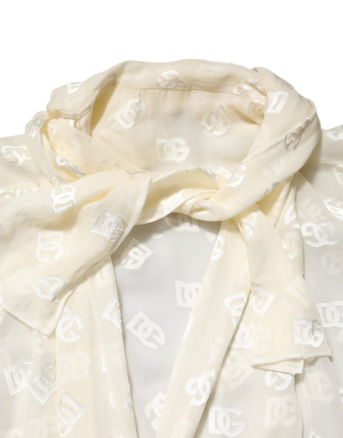 Indulge in the exquisite Dolce & Gabbana Off White Logo Monogram Ascot Collar Top, crafted from luxurious viscose and silk, embodying timeless elegance and sophisticated allure.