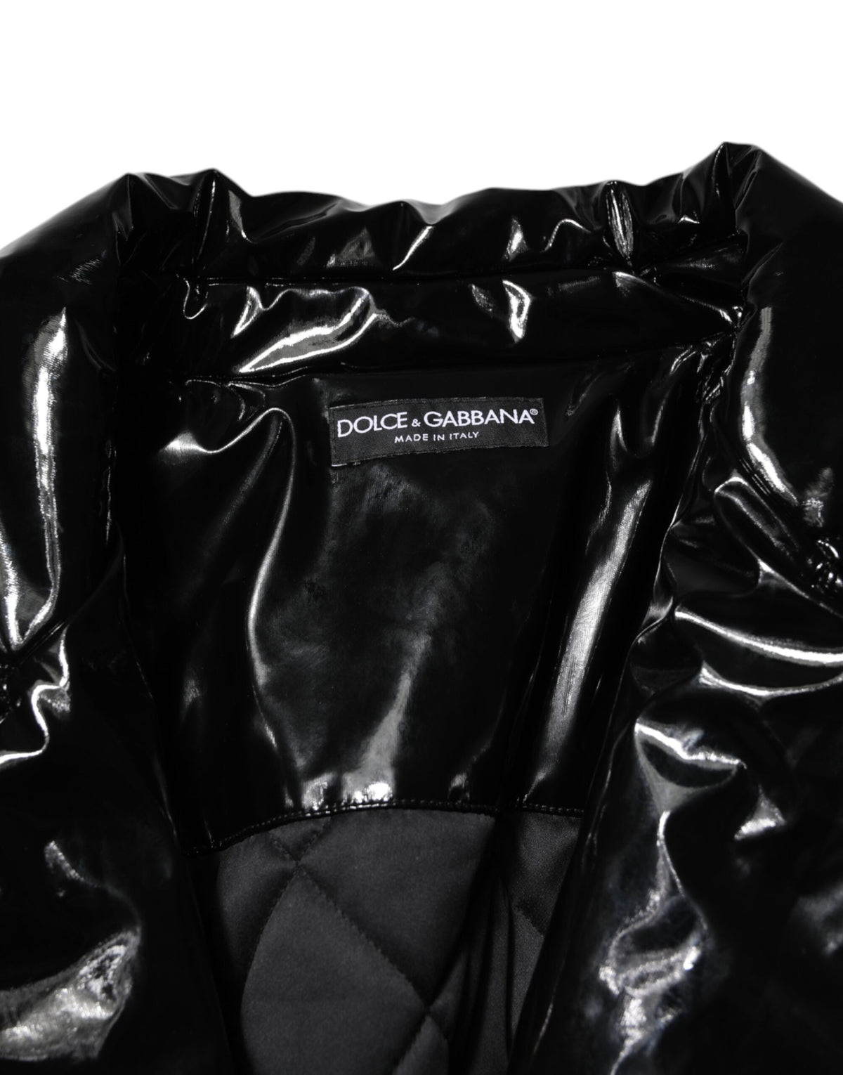 Indulge in the exquisite Dolce & Gabbana Black Quilted Puffer Coat, a masterpiece of Italian craftsmanship that seamlessly blends warmth with sophisticated allure for the discerning individual.