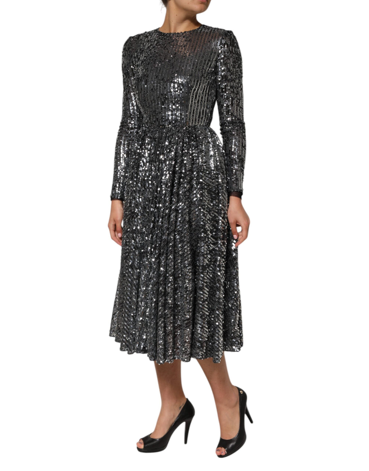 Indulge in the allure of the Dolce & Gabbana Black Sequined Long Sleeves Midi A-line Dress, a masterpiece of Italian craftsmanship that embodies timeless elegance and sophistication.