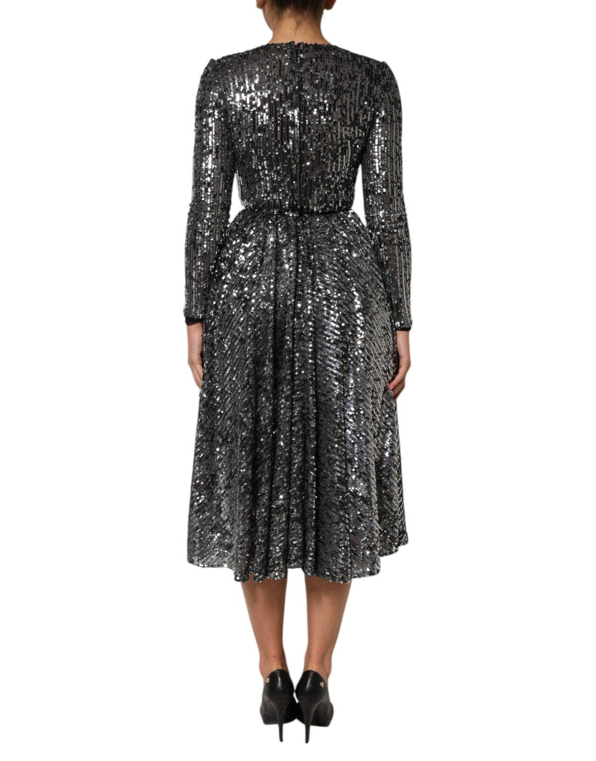 Discover the Dolce & Gabbana Black Sequined Long Sleeves Midi A-line Dress, a masterpiece of Italian craftsmanship, blending luxurious materials for timeless elegance.