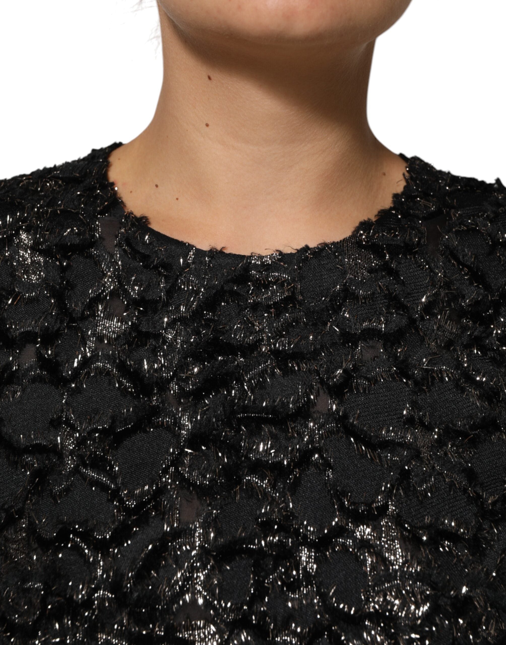 Indulge in the Dolce & Gabbana Black Sequin Bouclé Tweed Sheath Dress, a masterpiece of Italian craftsmanship that radiates timeless elegance and allure.