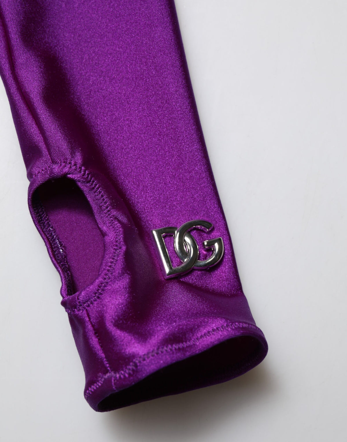 Indulge in the exquisite Dolce & Gabbana Purple Nylon Turtleneck Bodycon Jumpsuit Dress, where luxurious Italian craftsmanship meets timeless elegance, perfect for the discerning individual.
