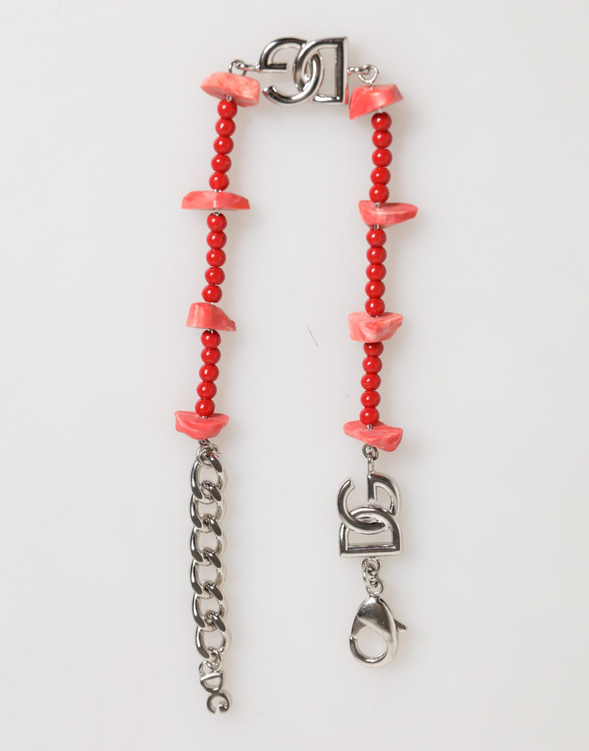 Discover the Dolce & Gabbana Silver Tone Brass Beaded Resin DG Logo Chain Bracelet, a masterpiece of Italian craftsmanship that embodies timeless elegance and luxury.