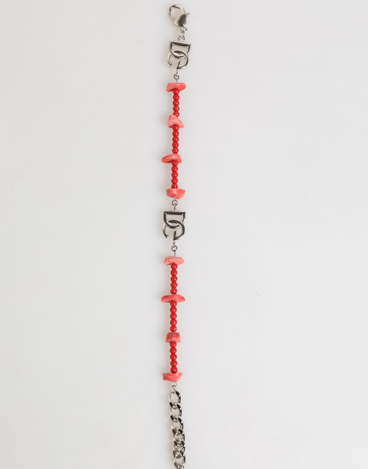Elevate your style with the Dolce & Gabbana Silver Tone Brass Beaded Resin DG Logo Chain Bracelet, a masterpiece of Italian craftsmanship that embodies timeless elegance and luxury.