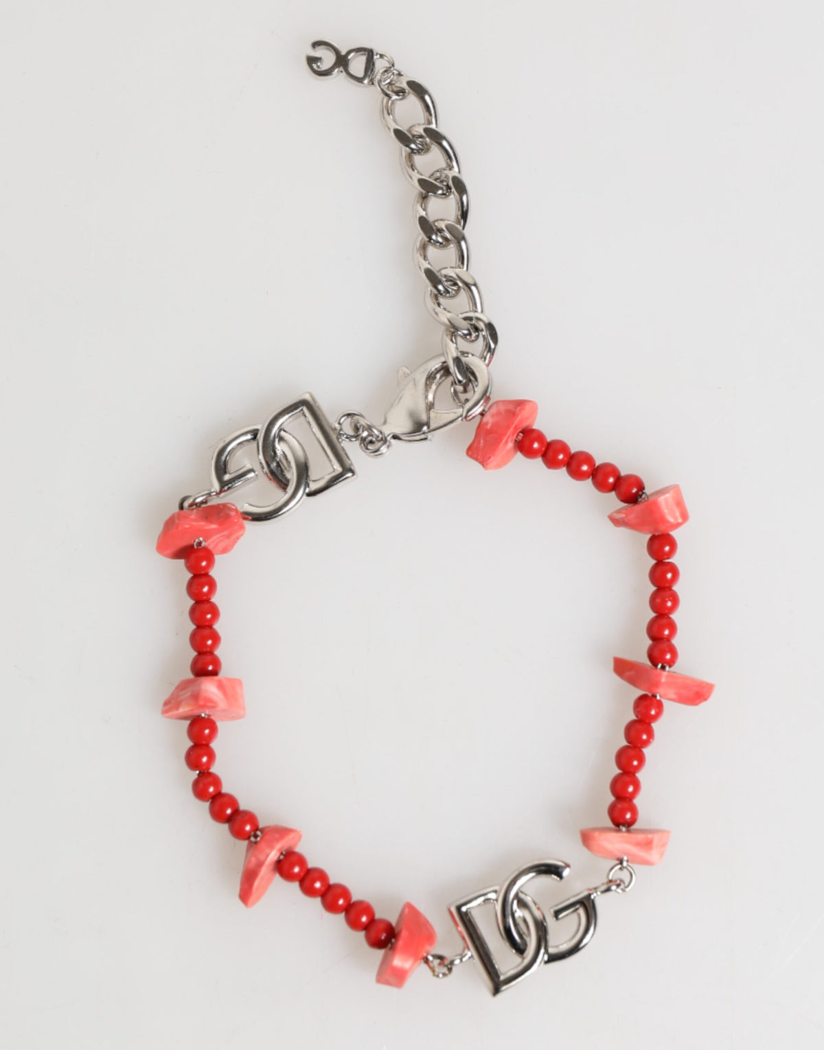Elevate your style with the Dolce & Gabbana Silver Tone Brass Beaded Resin DG Logo Chain Bracelet, a masterpiece of Italian craftsmanship that embodies timeless elegance and luxury.