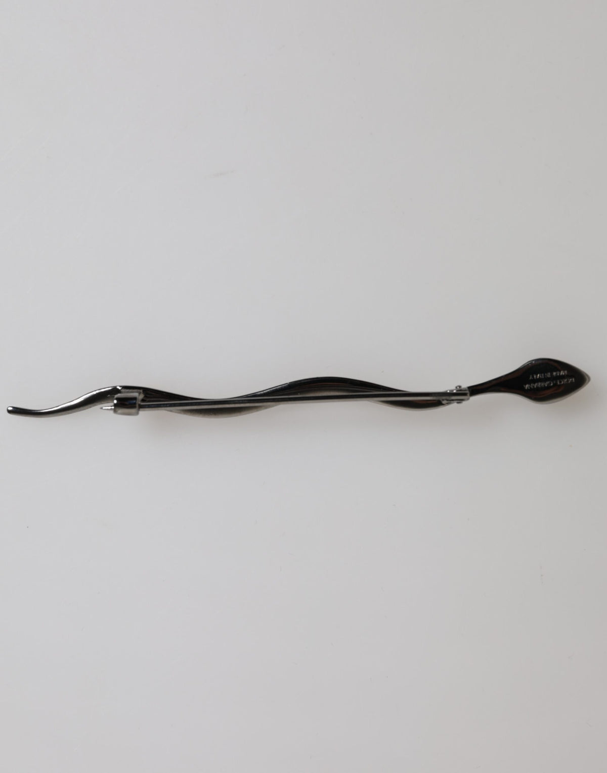 Indulge in the exquisite Dolce & Gabbana Black Brass Crystal Spilla Serpente Brooch, a timeless statement of elegance, crafted from luxurious materials for the discerning connoisseur.