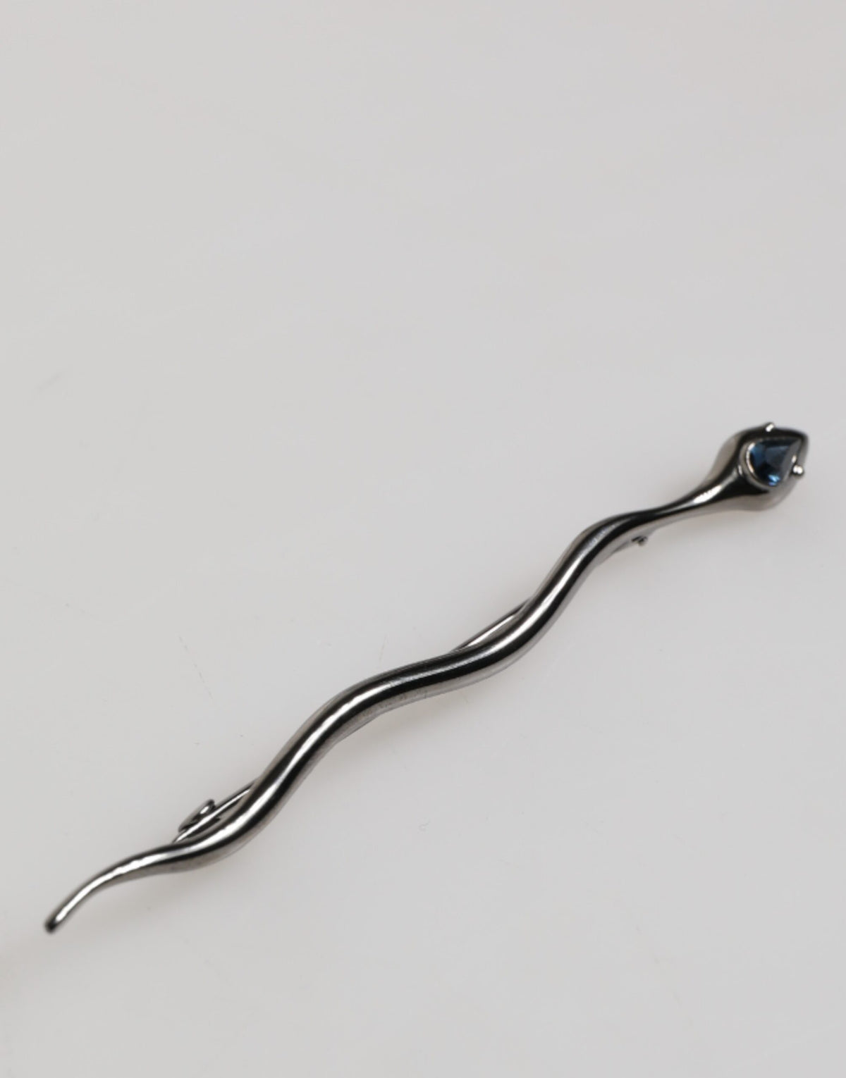 Discover the exquisite Dolce & Gabbana Black Brass Crystal Spilla Serpente Brooch, a timeless statement of luxury and artistry, perfect for the discerning connoisseur.